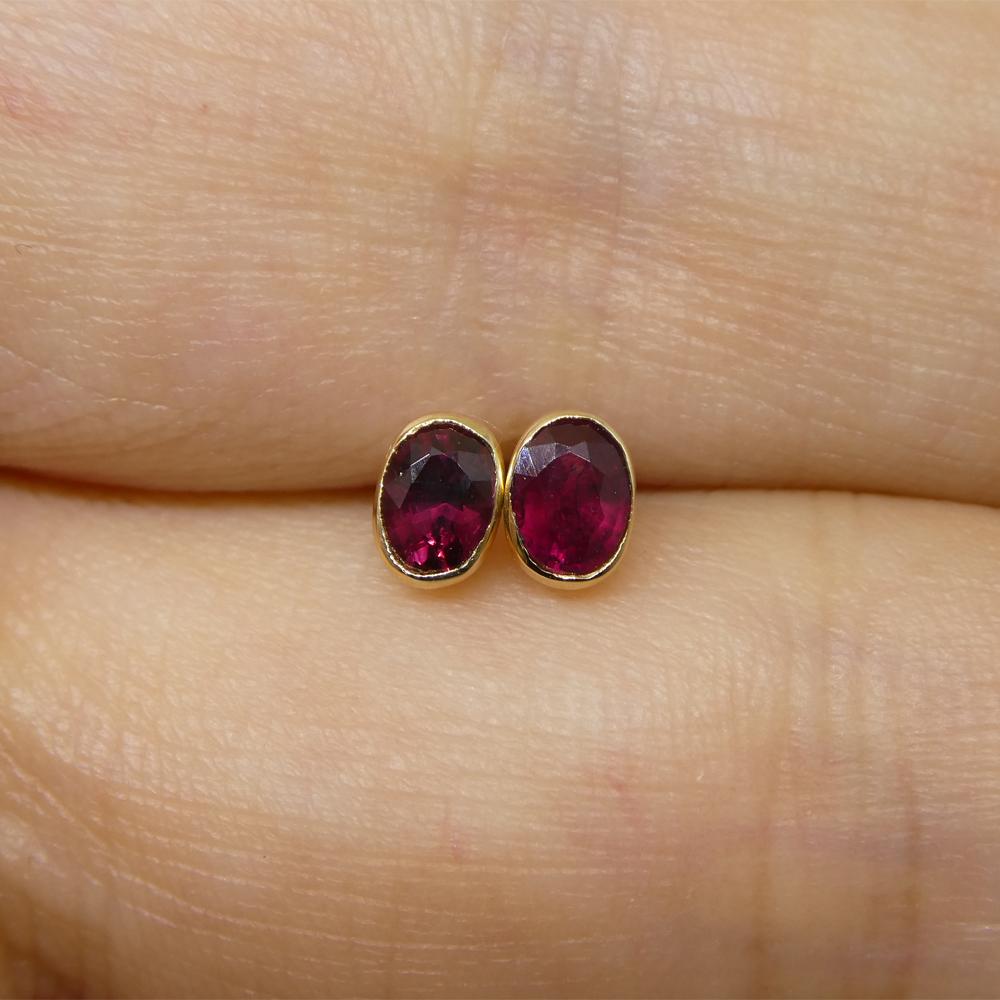 Women's or Men's 0.42ct Oval Red Ruby Stud Earrings set in 14k Yellow Gold For Sale