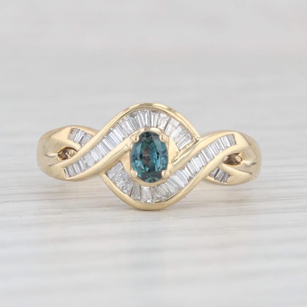 Gemstone Information:
- Natural Alexandrite -
Carats - 0.24ct 
Cut - Oval Brilliant
Color - Teal Blue Green

- Natural Diamonds -
Total Carats - 0.18ctw
Cut - Baguette
Color - F - G
Clarity - VS2 - SI1

Metal: 18k Yellow Gold
Weight: 4.6 Grams