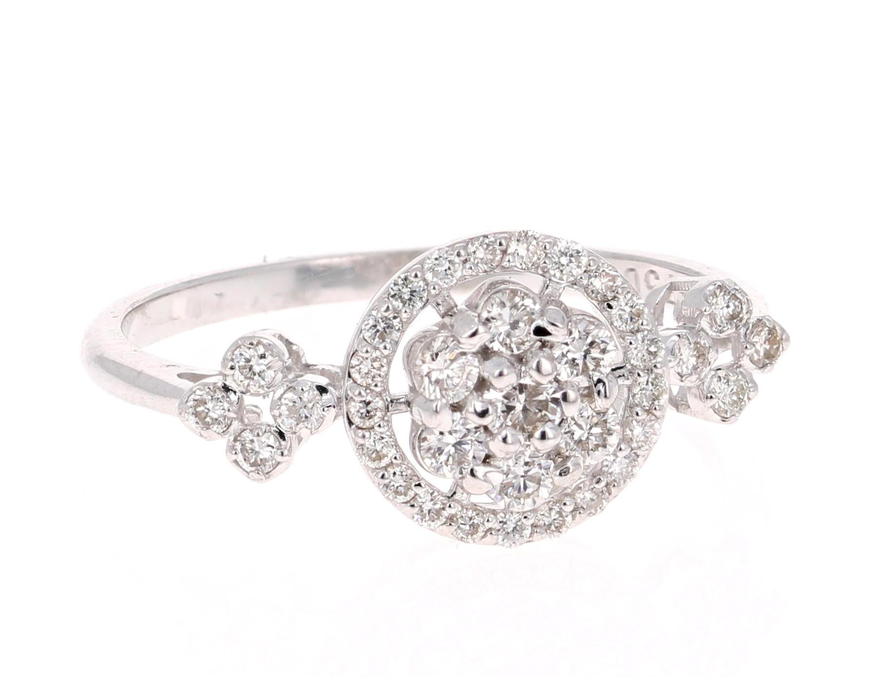A cute and dainty diamond cluster ring!

The ring has 36 Round Cut Diamonds that weigh 0.43 Carats. The clarity and color of the diamonds are VS2-H. 

It is set in 18K White Gold and is 2.3 grams. The ring size is a 6.5 and can be resized if needed