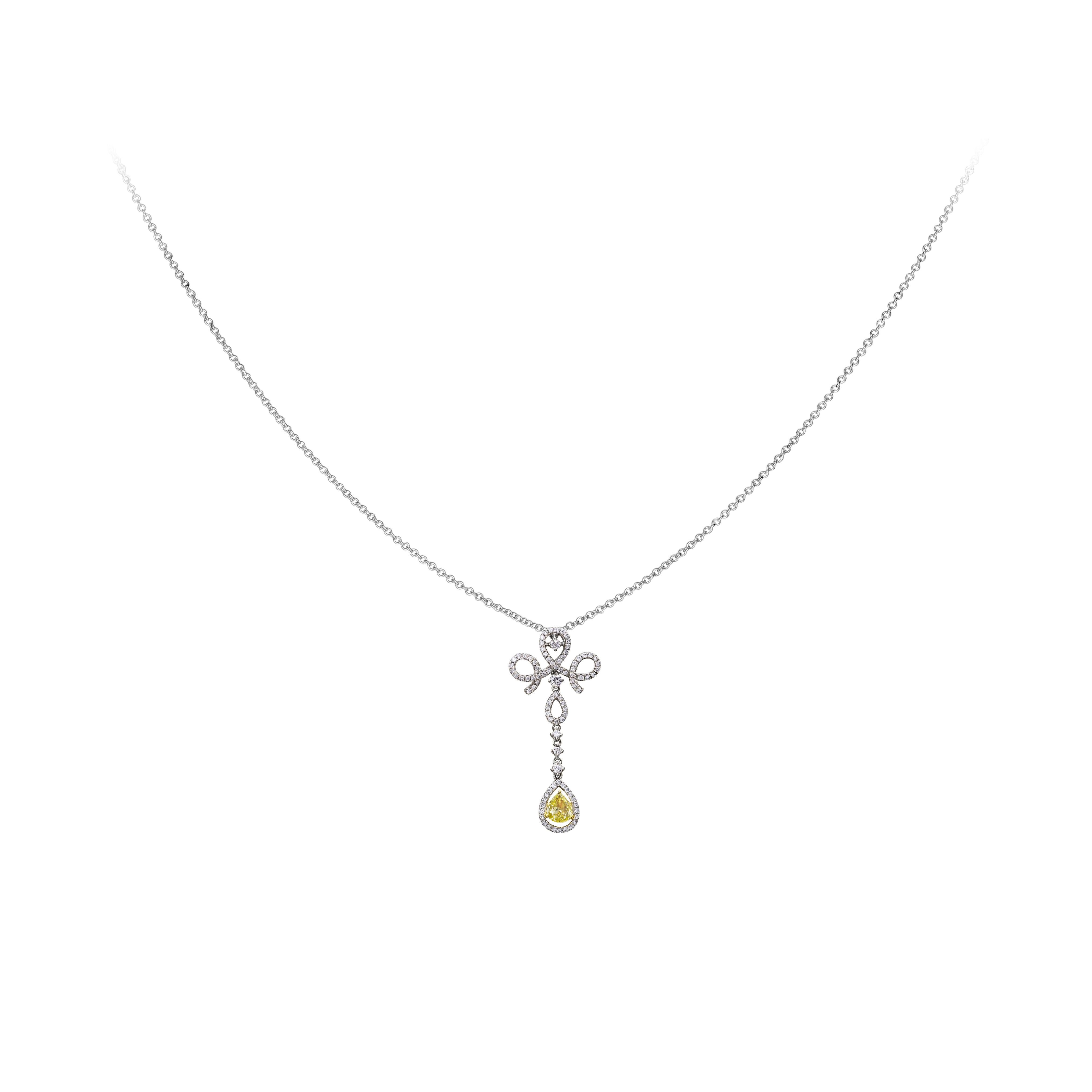 Features a fancy yellow pear shape diamond center weighing 0.43 carats  set in an open-work mounting embellished by round brilliant diamonds weighing 0.63 carats. Made in 18k white gold. Attached to a 16 inch adjustable white gold chain.

Style