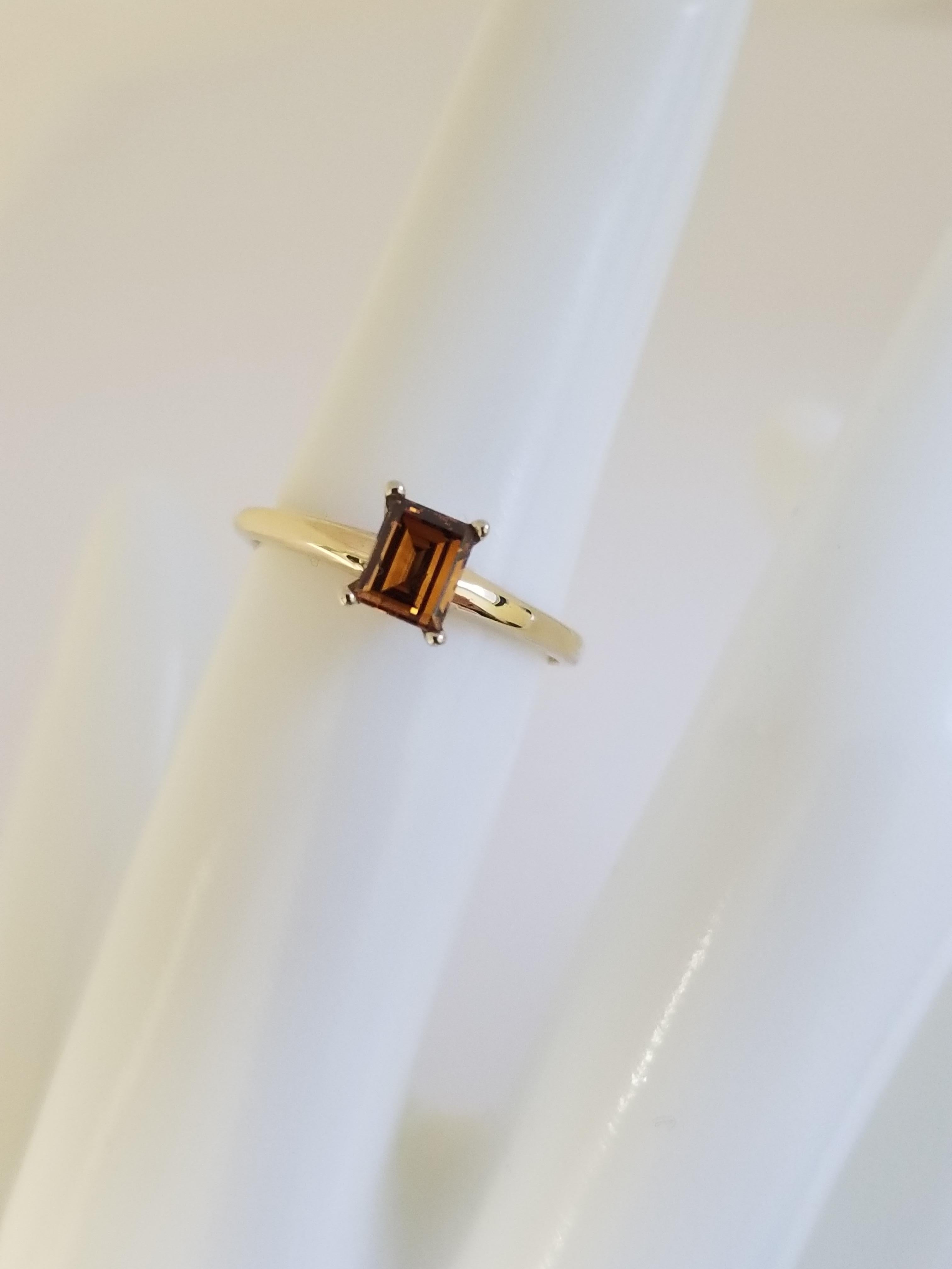 All Natural Fancy Deep Orangy Brown Color Emerald Cut Diamond Set on 2 tone 4 Prong Solitaire Ring Weighing 0.44 carats by IGI. Elegance for every occasion.

Ring Size: 5.75
Color Fancy Deep Orangy Brown 
Clarity I
Yellow Gold Ring 14k with 4 prong