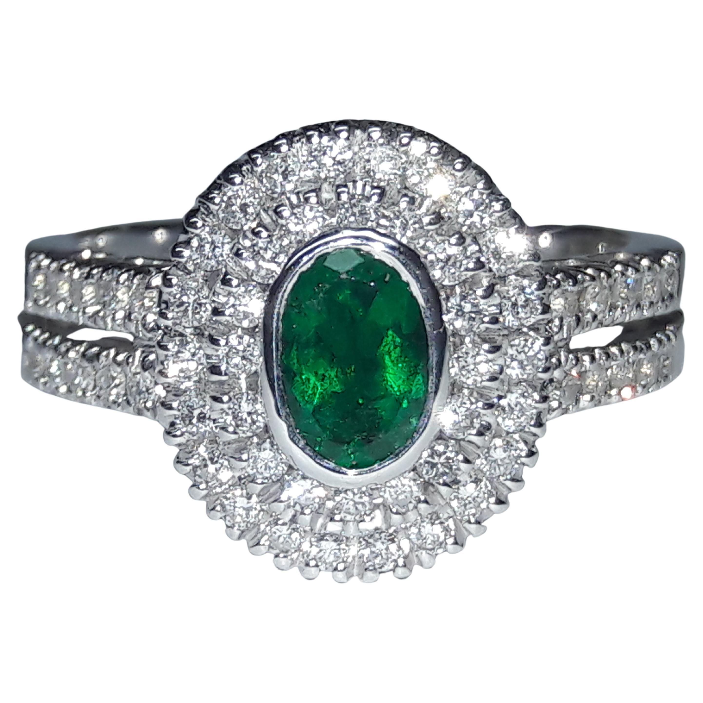 0.44 Carat Natural Oval Emerald 0.48 Carat white Diamonds 18 Karat Gold Ring
This ring was made in Italy and has the hallmark 750 gold which is the equivalent of the US 18k gold.