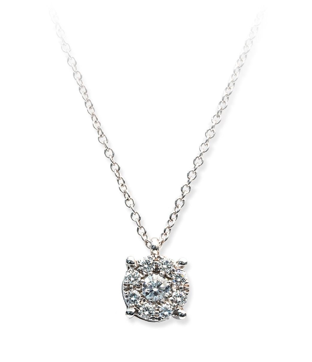 This exquisite Magic pendant features a dazzling central round brilliant-cut diamond weighing 0.20 Ct, boasting a stunning E-F color grade and VS clarity. The captivating centerpiece is elegantly complemented by additional diamonds, contributing to