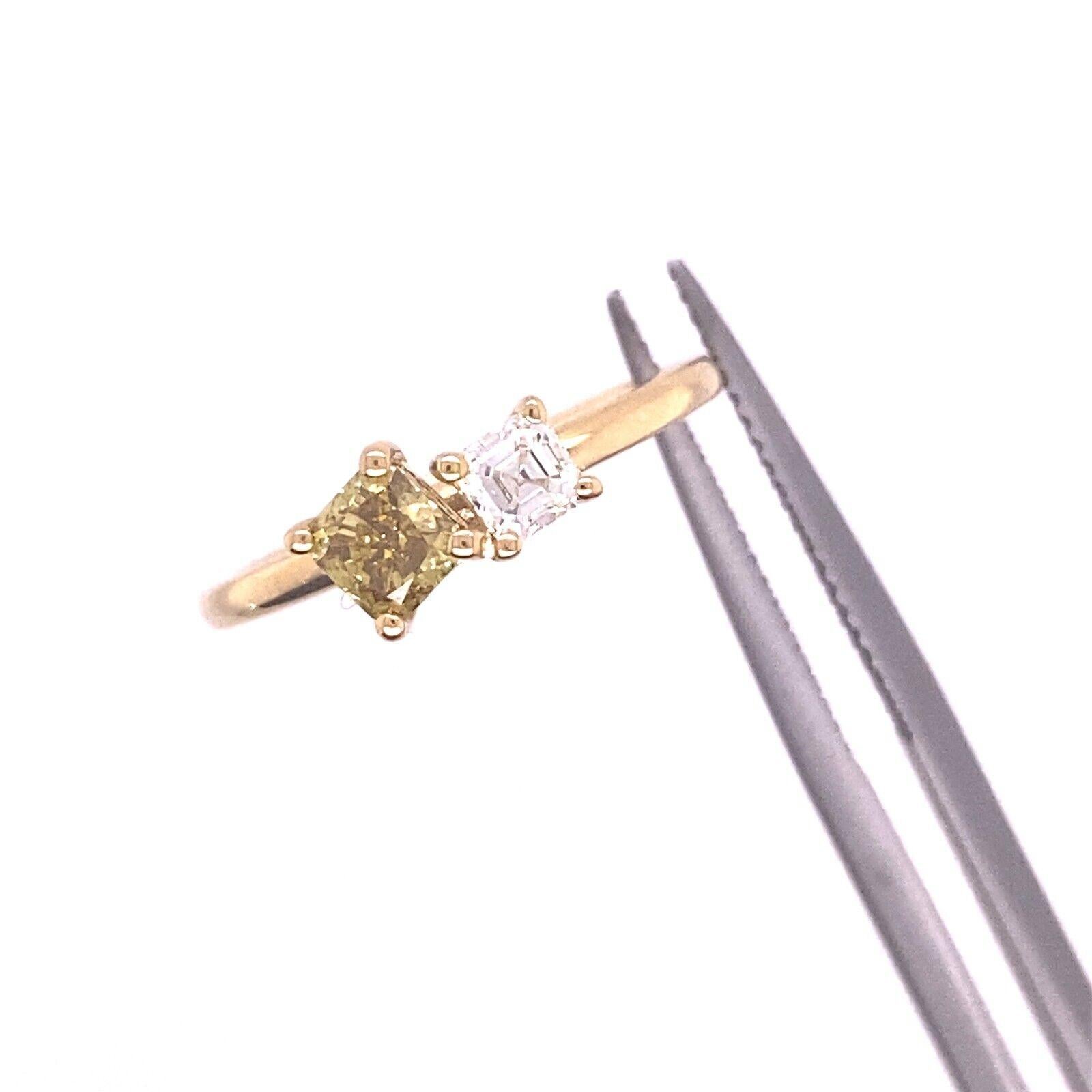 This beautiful ring features a certified 0.44ct natural fancy deep yellowish green square Diamond and 0.23ct G/VS asscher cut Diamond. 
This elegant ring is set on a 18ct Yellow Gold band and is perfect for everyday wear.

Additional Information: