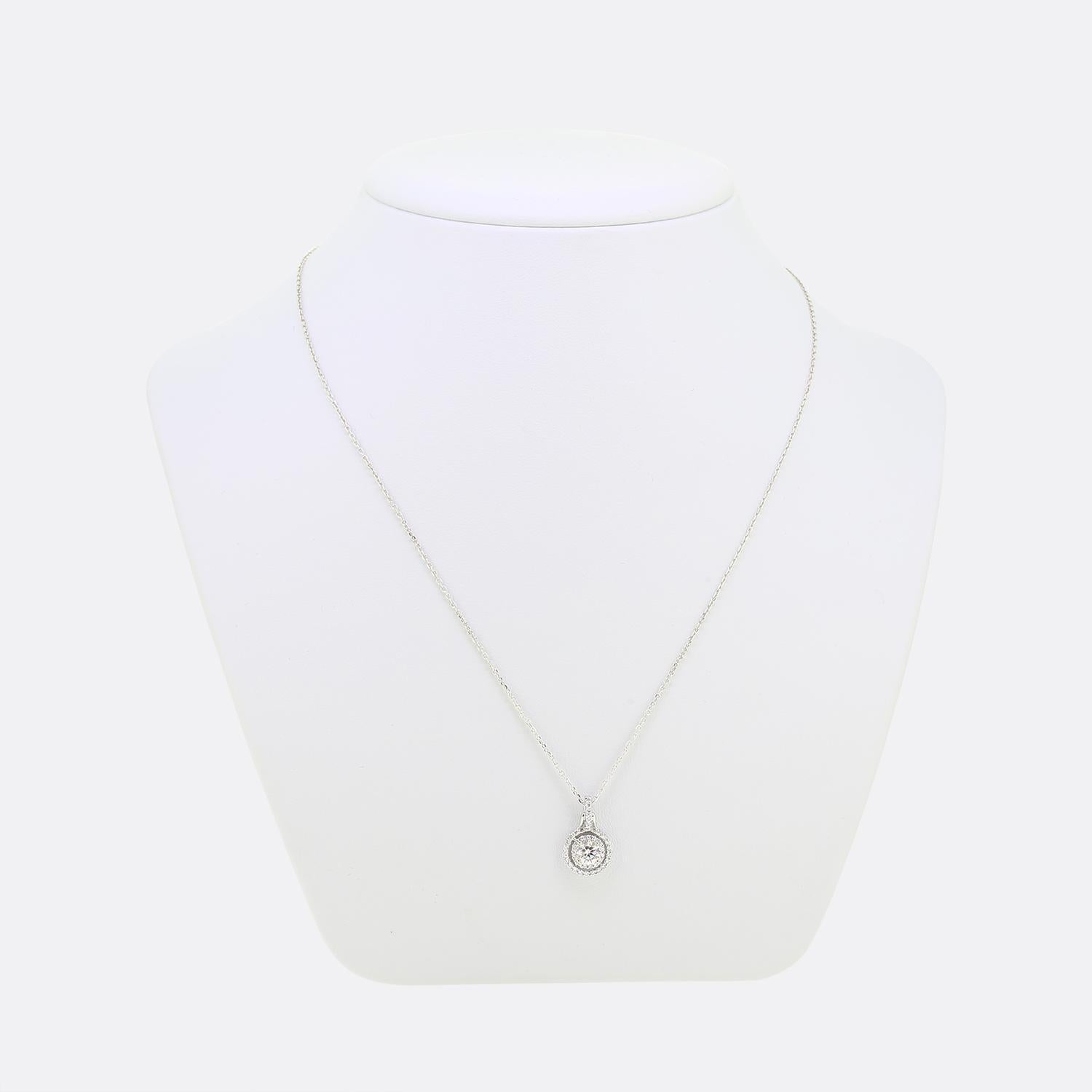 Here we have a delightful diamond halo pendant necklace. This pendant has been crafted from 14ct white gold and plays host to a single 0.45ct round brilliant cut diamond. This principal stone sits slightly risen in a four-clawed setting at the