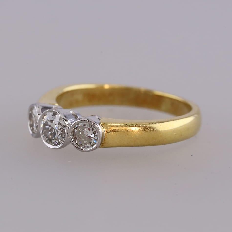 This is an 18ct yellow gold diamond three stone ring. Each of the 3 diamonds are rub-over set in white gold.

Condition: Used (Good)
Weight: 3.3 grams
Size: M
Total Carat Weight: Approx. 0.45 carats
Diamond Details: Colour: H-I, Clarity: