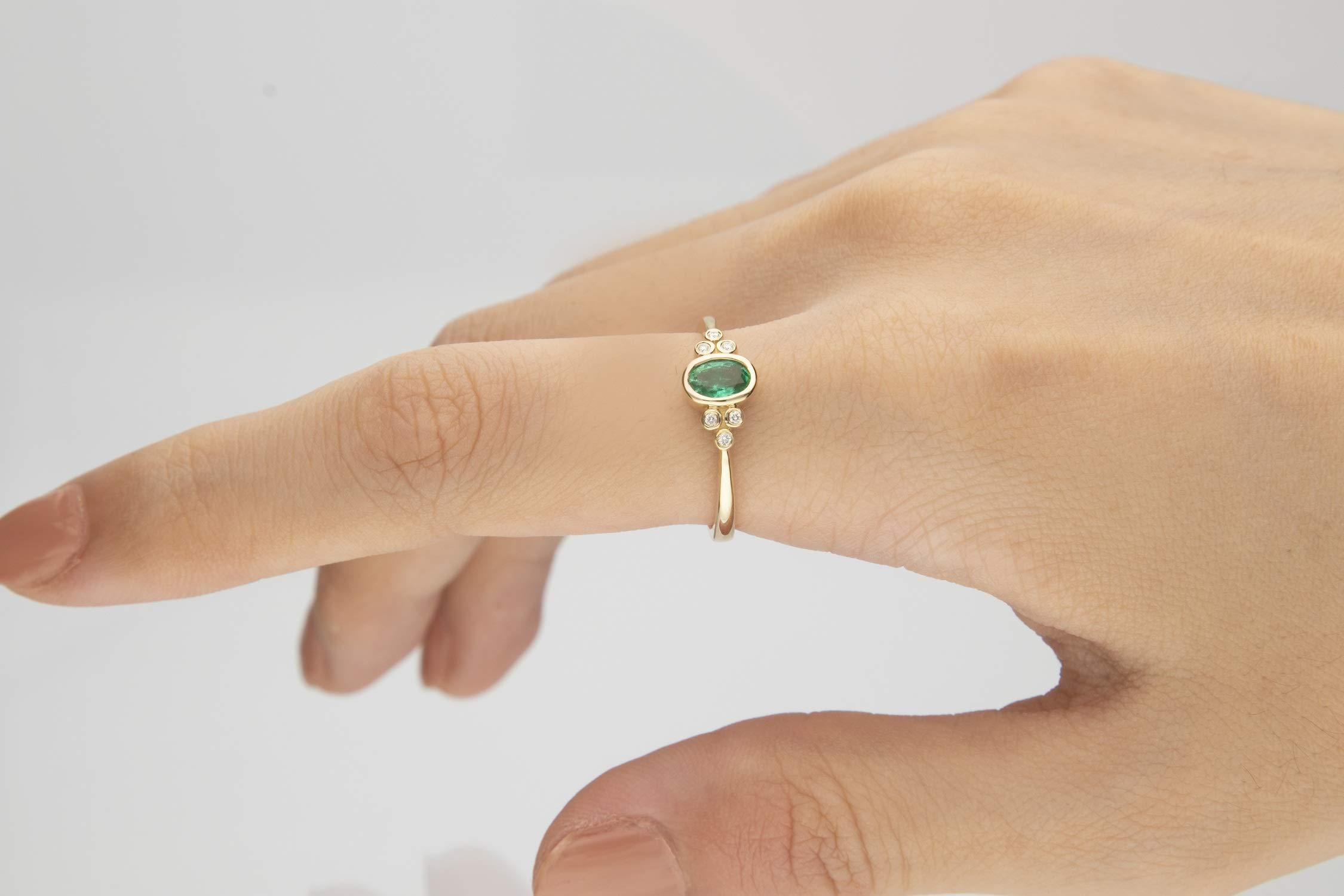 Stunning, timeless and classy eternity Unique ring. Decorate yourself in luxury with this Gin & Grace ring. The 10k Yellow Gold jewelry boasts 4X6 Oval-Cut Bezel Setting Natural Emerald (1pcs) 0.45 Carat and Round-Cut Bezel Setting Diamond (6pcs)