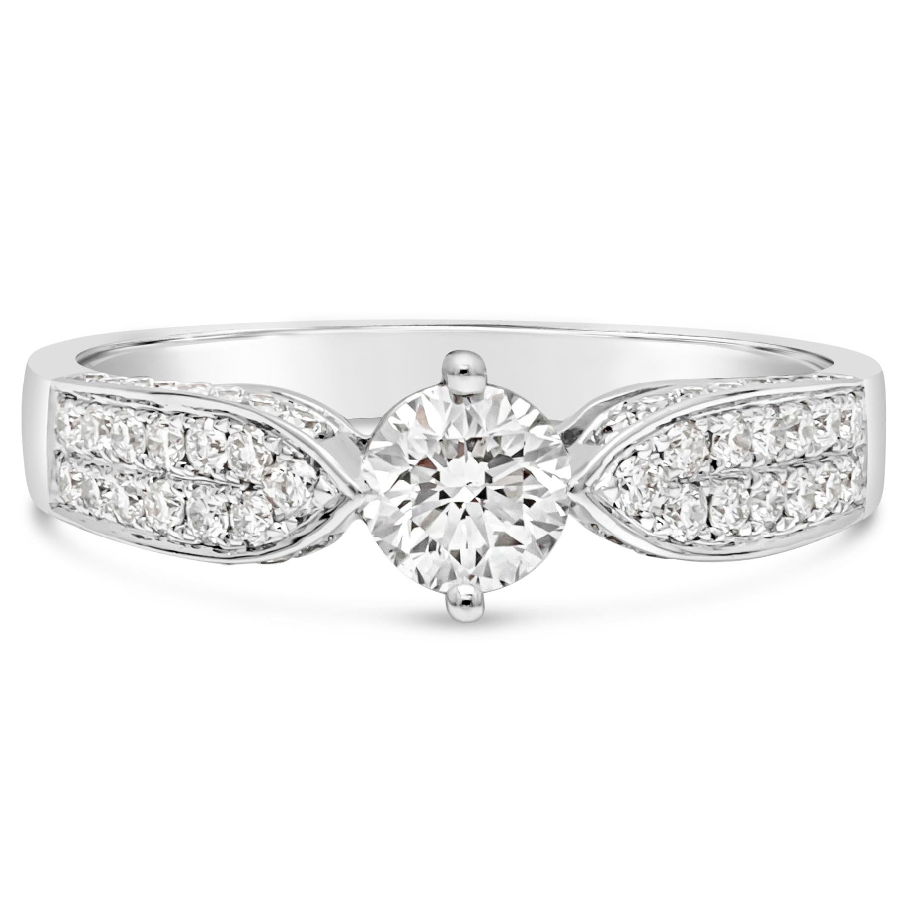 Features a 0.45 carat round brilliant diamond center stone set in a 18K white gold setting that tapers as it gets to the center diamond. The setting is micro-pave set with round brilliant melee diamonds on either side. Unique placement of the prongs
