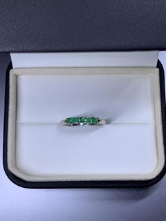 0.45ct Colombian green emerald eternity wedding ring in platinum