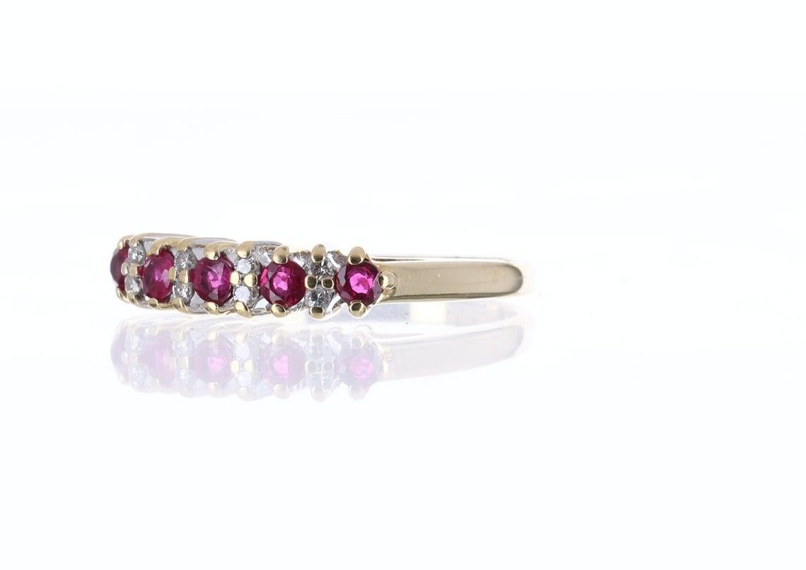 Beautiful and unique high quality natural ruby & diamond engagement or wedding band. This delicate, rare fire ruby wedding band is hand made of solid yellow gold and set with natural white diamonds. Perfect as a wedding or anniversary gift.

Setting