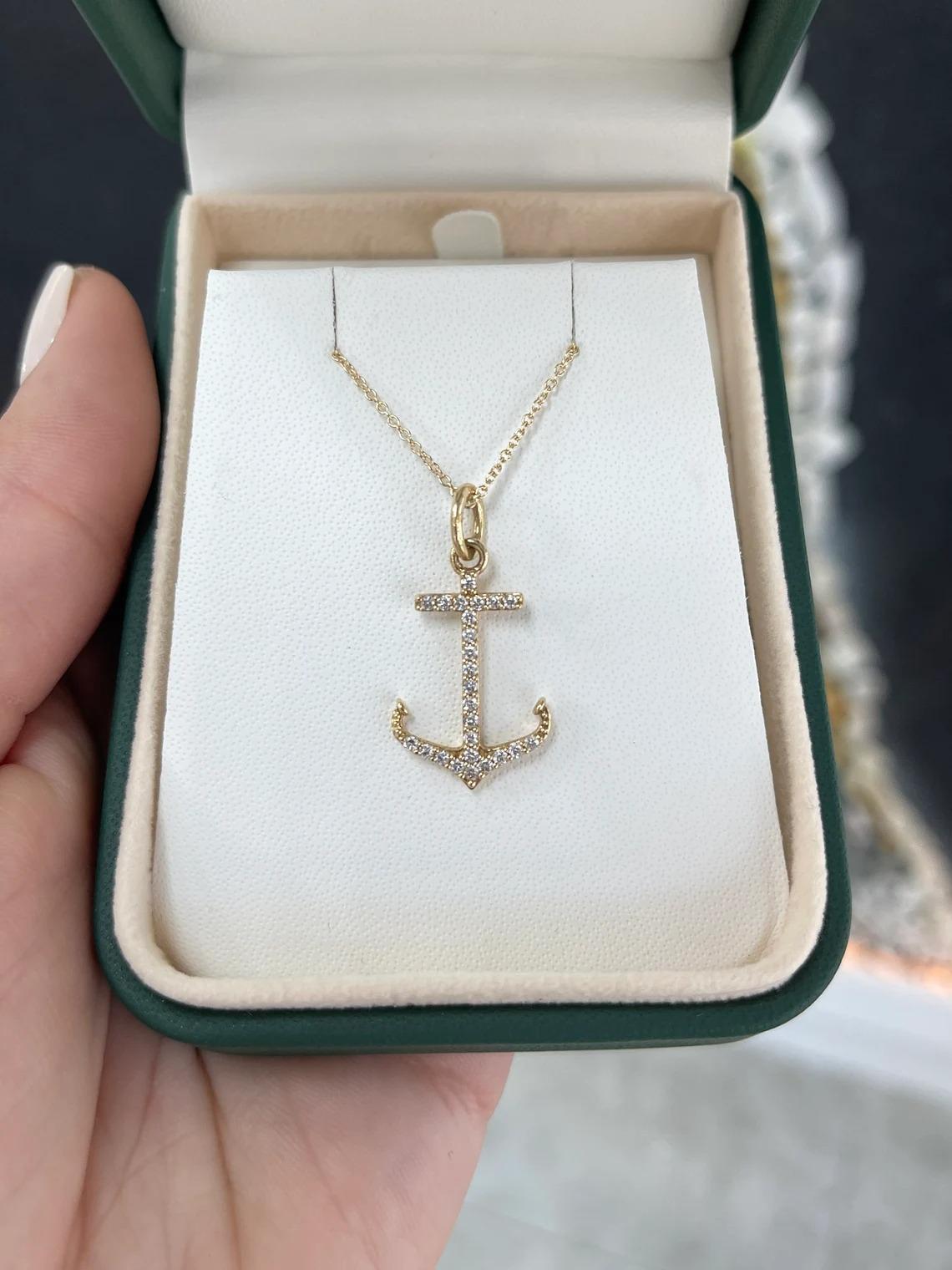 A gorgeous diamond anchor pendant in 14K yellow gold. This magical piece features twenty-five brilliant round-cut diamonds that go within the outline of the anchor and make it fully 