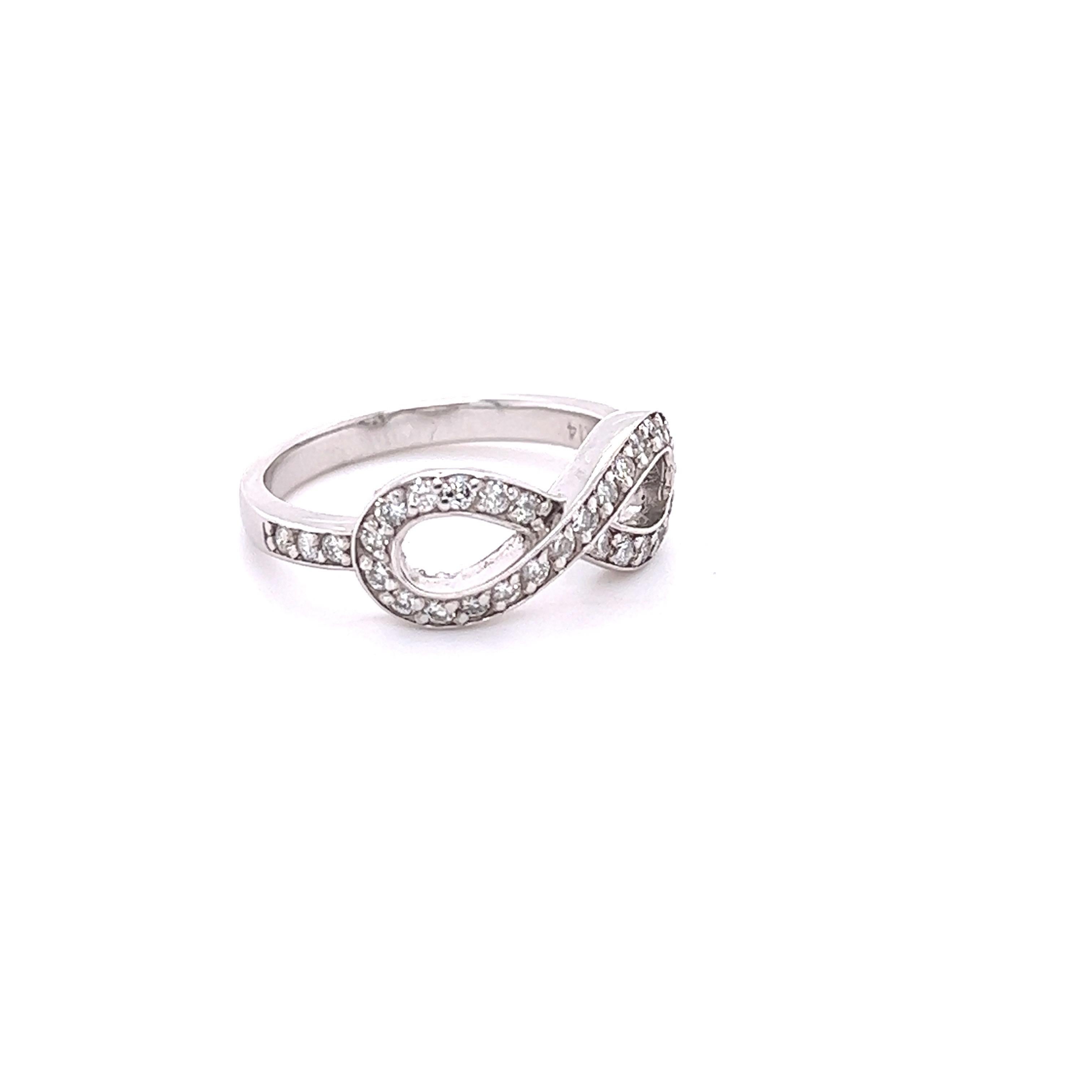 This ring has 32 Round Cut Diamonds that weigh 0.46 carats. The clarity and color of the diamonds are SI2-F. 

The ring is designed in 14 Karat White Gold and weighs approximately 3.5 grams

The ring is a size 6.5 and can be re-sized free of charge.