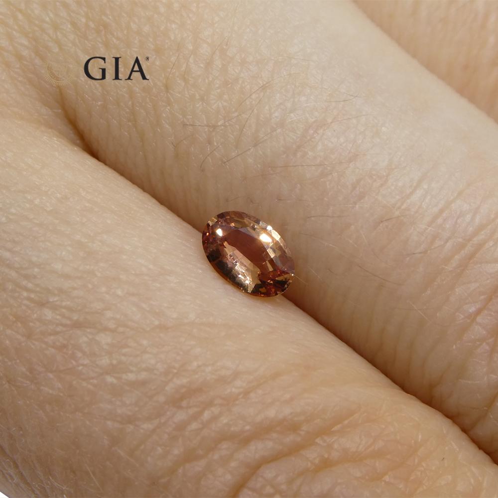 Women's or Men's 0.46 Carat Oval Pinkish Orange Padparadscha Sapphire Gia Certified Madagascar For Sale