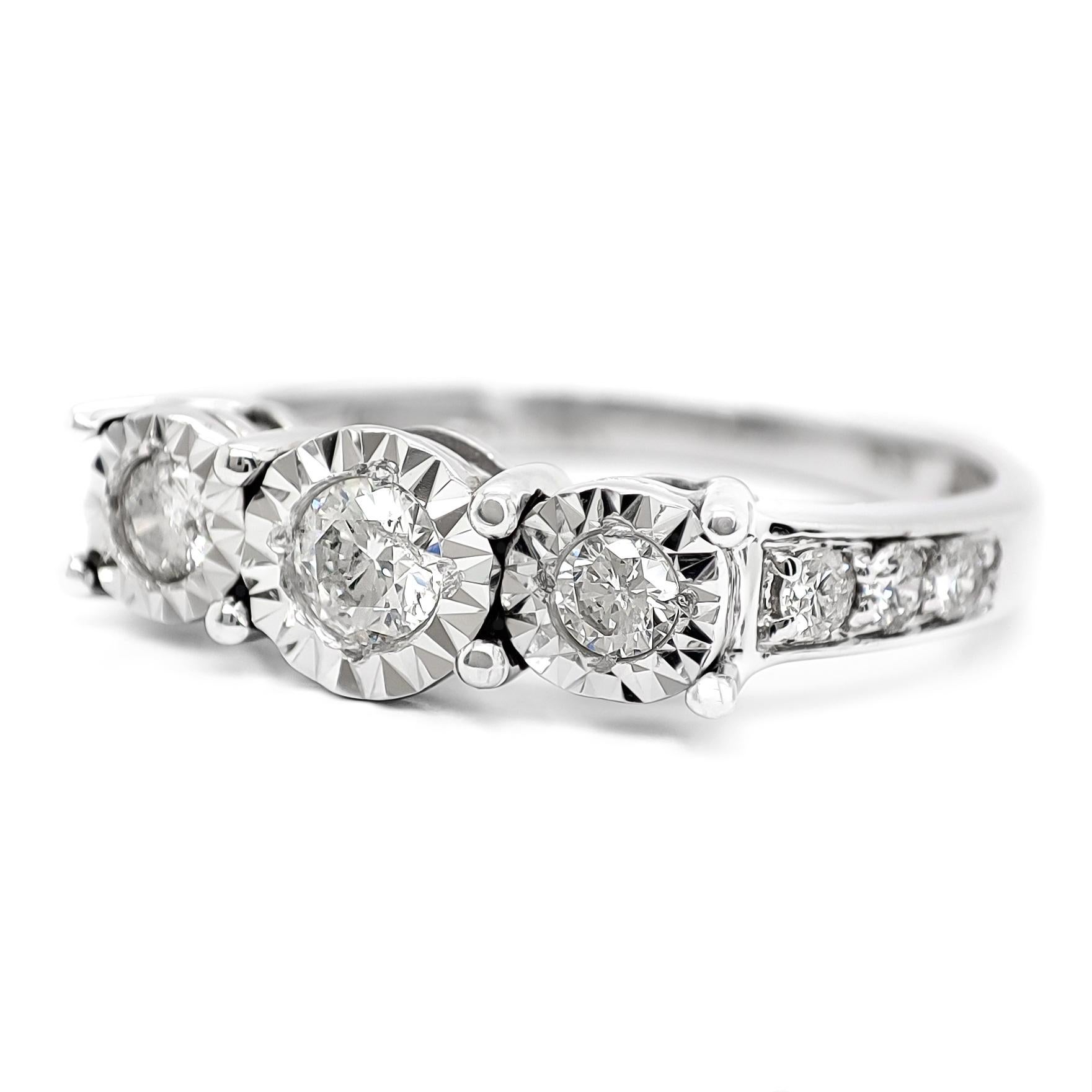 FOR THE USA CUSTOMERS NO VAT

Imagine a mesmerizing 0.47 carat round brilliant diamond ring, cradled in the elegance of 14K white gold. This exquisite piece boasts a constellation of 9 diamonds, collectively weighing 0.47 carats. These diamonds,