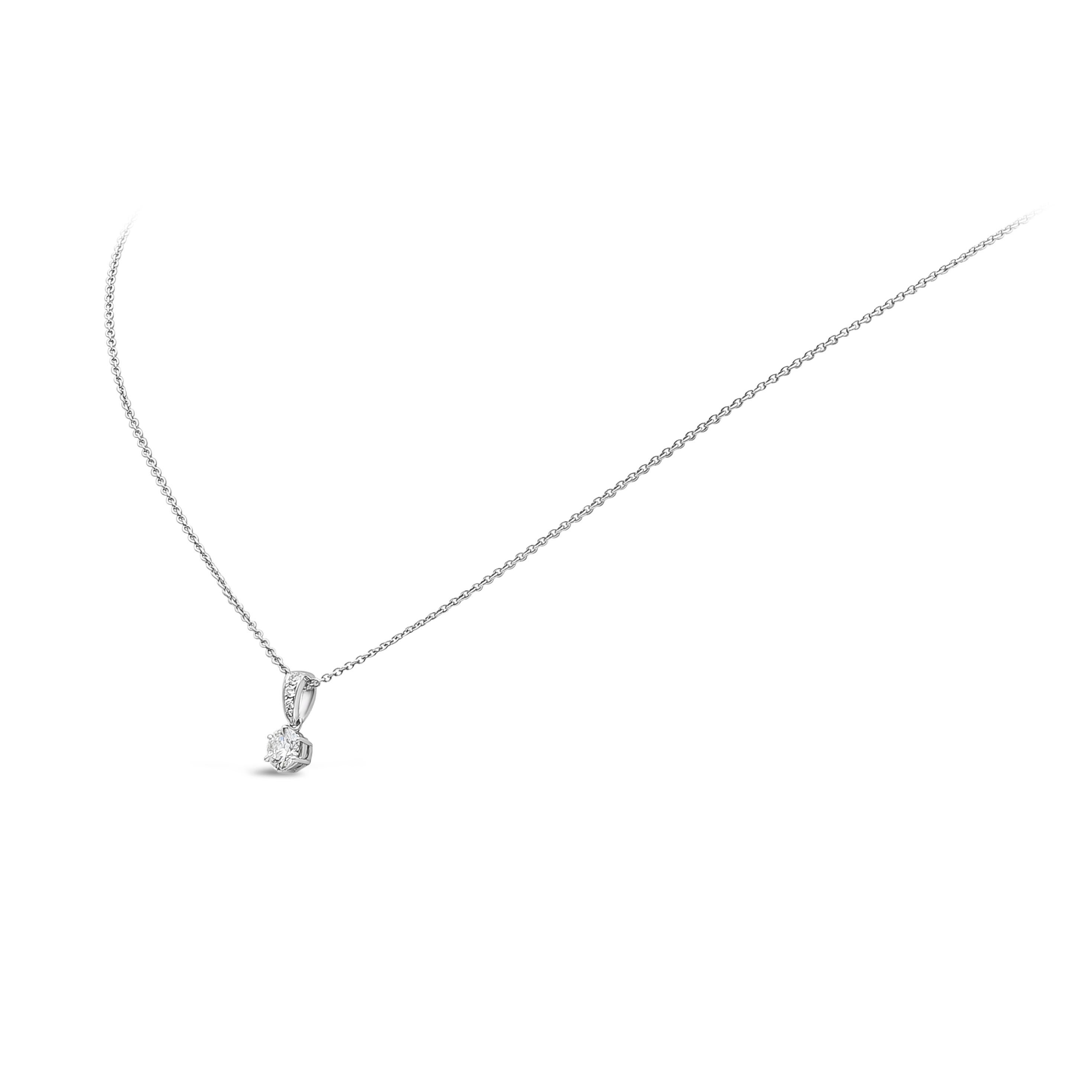 A simple and timeless pendant necklace, featuring a 0.43 carat round brilliant cut diamond beautifully crafted in a six prong basket and suspended on a diamond encrusted bail weighing 0.04 carat. The diamonds are F-G color and SI1-SI3 clarity. Made