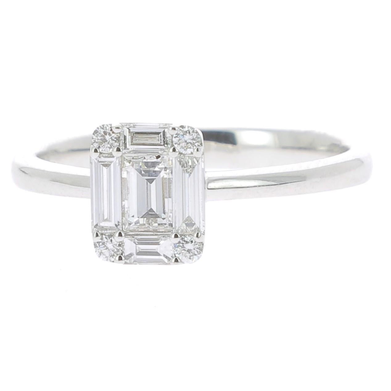 An unique Illusion Diamonds Ring set with Round Diamonds and Baguettes Diamonds giving the impression of One Emerald Cut Diamond.
The ring is set with 5 Baguettes Diamonds weighing 0.42 Carat, 4 Round Diamonds weighing 0.06 Carat 
Totally the
