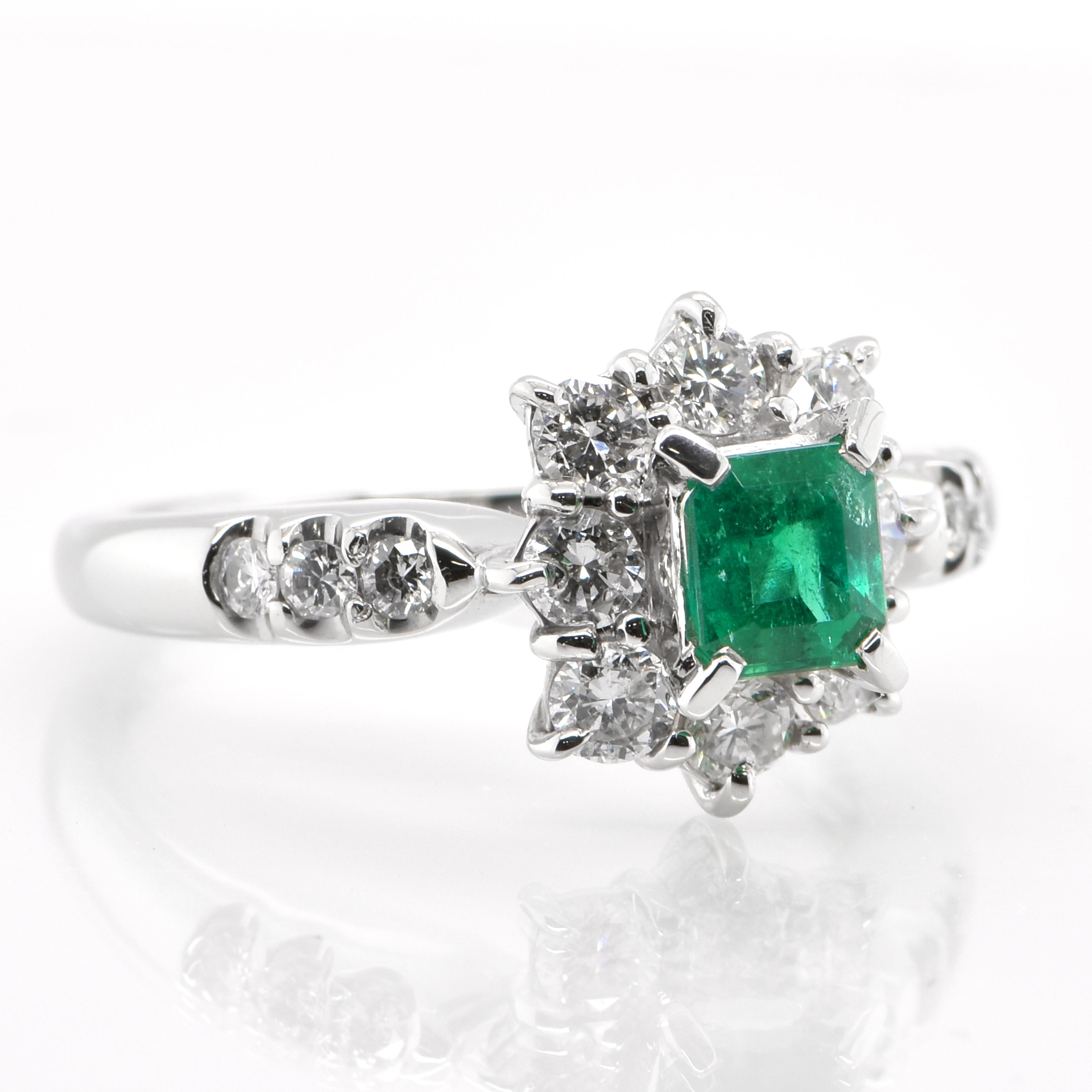 Modern 0.48 Carat Natural Emerald and Diamond Halo Ring Set in Platinum
