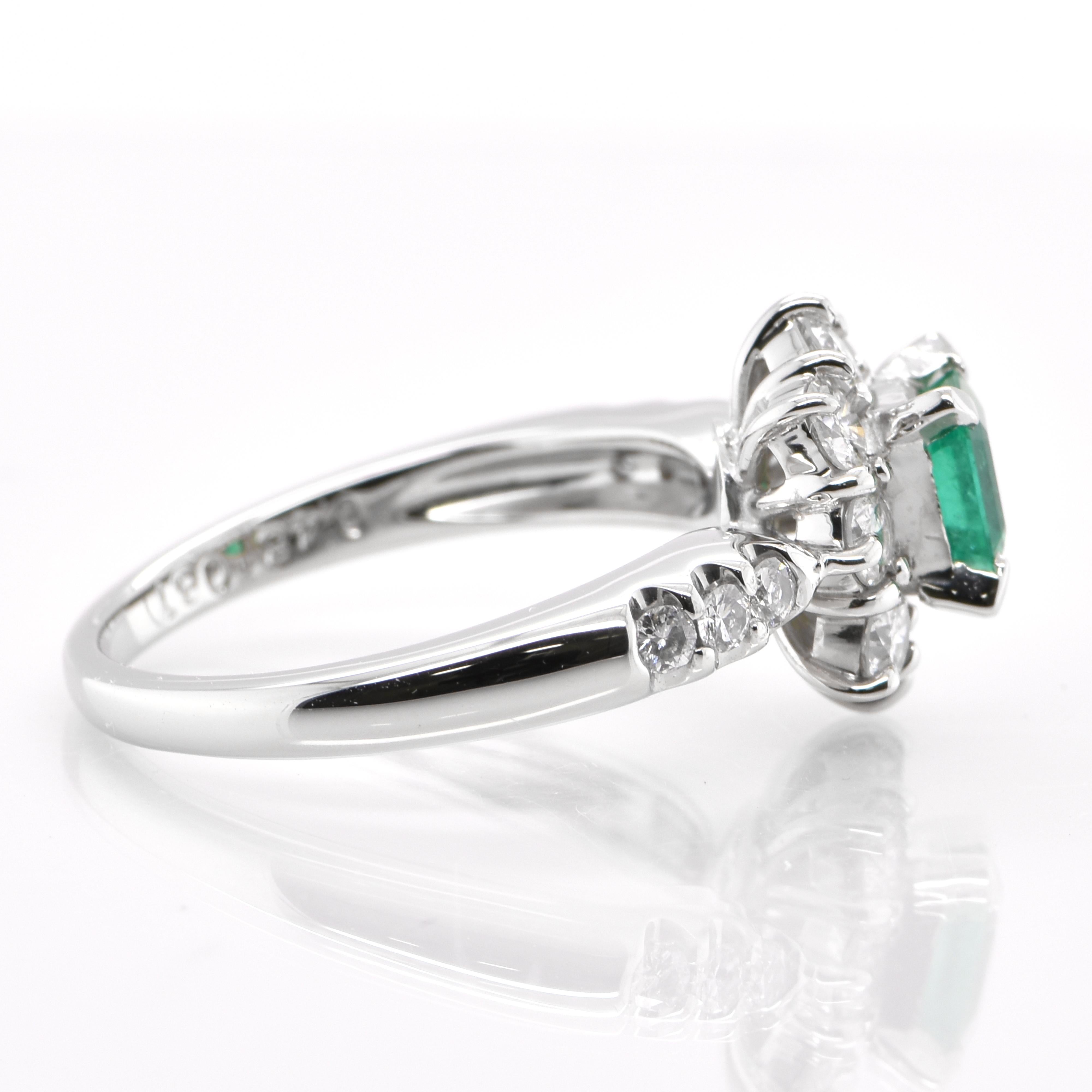 0.48 Carat Natural Emerald and Diamond Halo Ring Set in Platinum In New Condition In Tokyo, JP