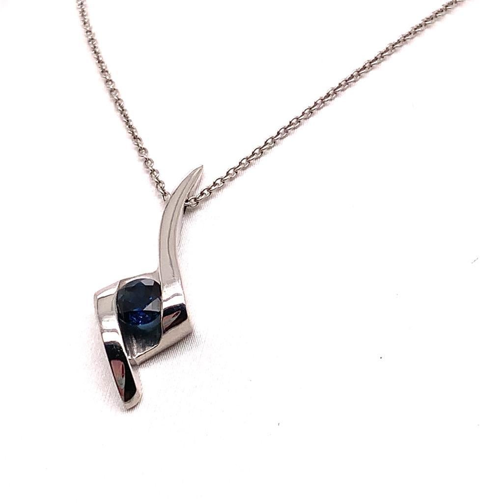 This stylish pendant features a delicate solitaire round brilliant Blue Sapphire weighing approximately 0.48 carats which is set in 18K white gold, giving it a flawless finish. The sleekness of this pendant captures the attention of all who set