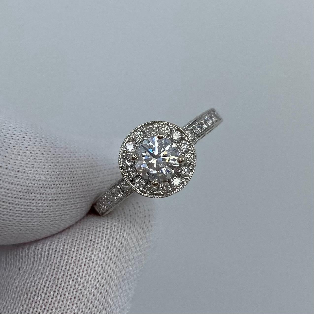 Round White Diamond 18k White Gold Halo Ring.

A beautiful 18 Karat white gold diamond halo ring with pave-set diamonds on the shoulders and around the setting.
0.48 Carat centre diamond with SI2 clarity and G/H colour, also has an excellent round