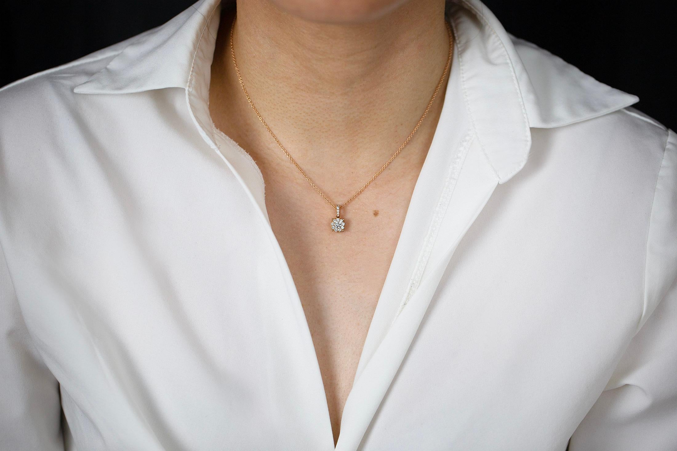 A simple yet unique pendant necklace showcasing a cluster of round brilliant diamonds weighing 0.48 carats total. Suspended on a diamond encrusted bale and 16 inch adjustable rose gold chain. Finely made in 16 inches rose gold.

Style available in