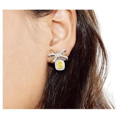 0.484 Carat Fancy Light Yellow Diamond Earrings VS Clarity AGL Certified