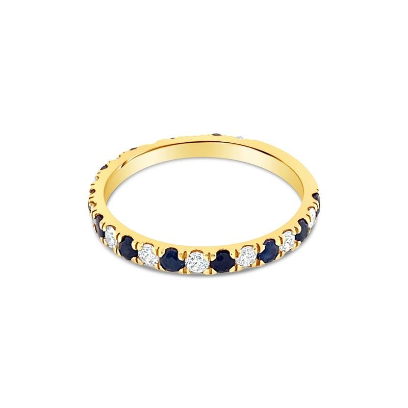 This band features 0.36 carat total weight in round diamonds alternating with 0.48 carat total weight in round blue sapphires, set in 18 karat yellow gold. It is currently a size 7 but can be resized upon request.