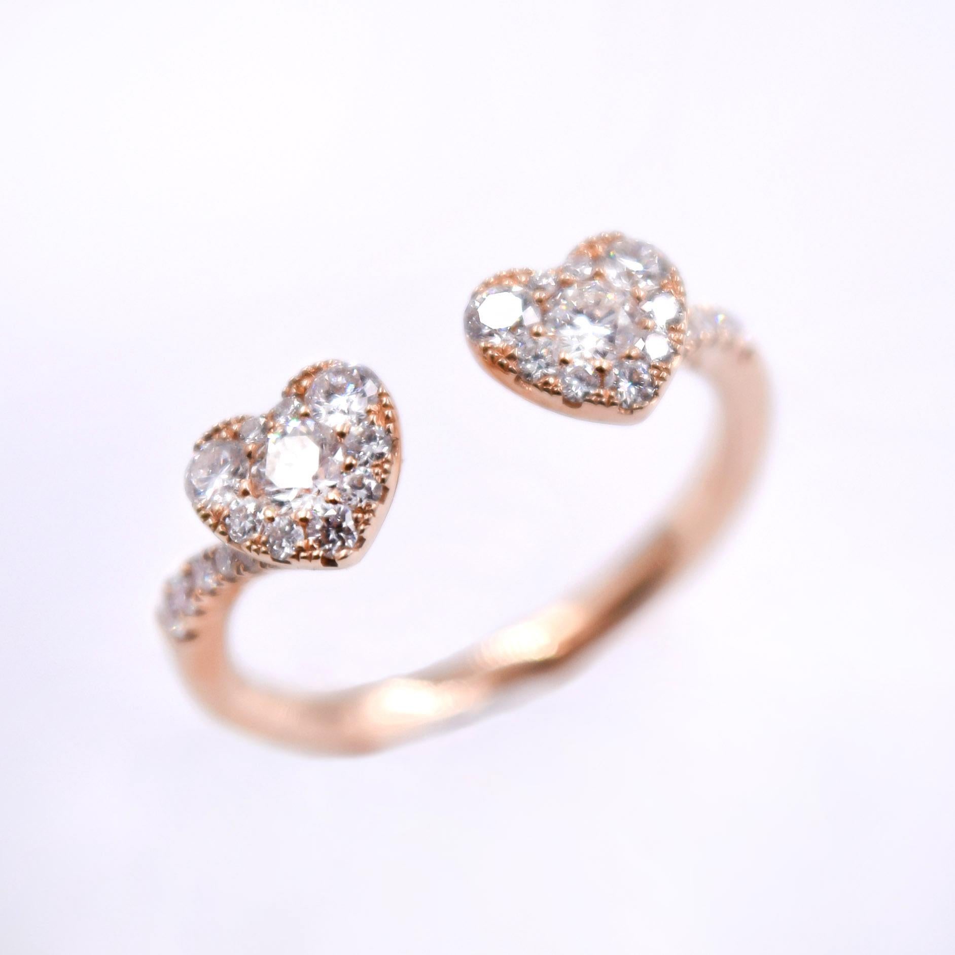 This beautiful ring is the perfect gift for her.

The ring features 0.49 carats of round white diamonds which are prong set in the heart shaped setting. Five round white diamonds are prong set on each side of the 18 karat rose gold shank. 
Size of