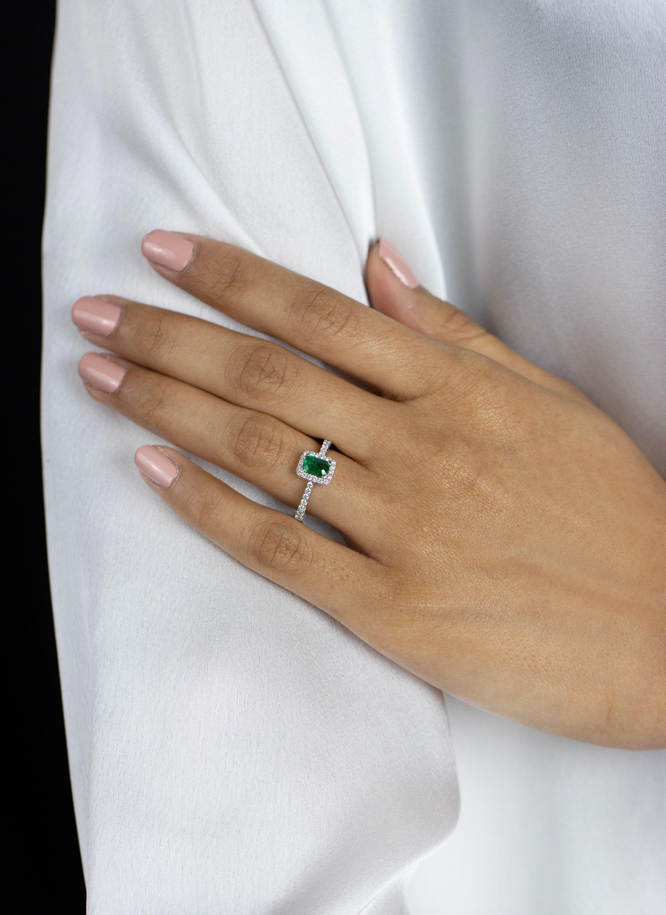 Women's 0.49 Carats Total Emerald Cut Green Emerald & Diamond Halo Engagement Ring For Sale