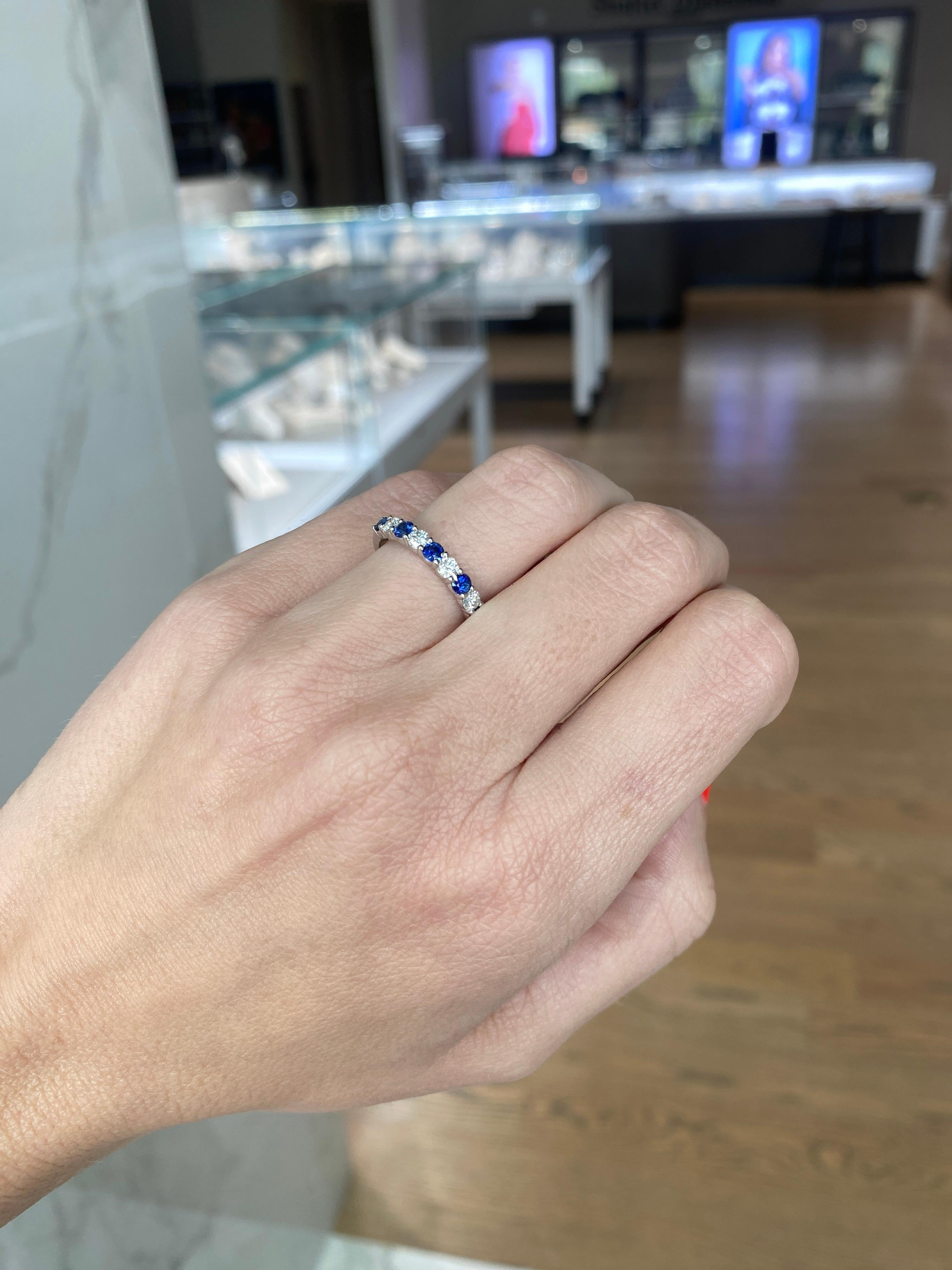 This band features 0.49 carat total weight in natural round blue sapphires alternating with 0.37 carat total weight in natural round diamonds set in 14 karat white gold. Stack with your other favorite rings or wear alone. This ring is a size 6.25