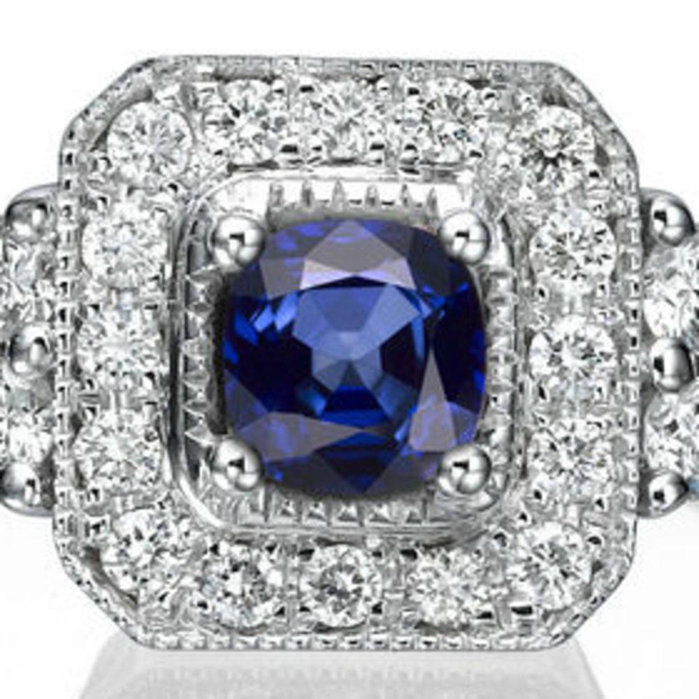 This beautiful Art Deco Style halo with accents vintage engagement ring is made of 14k milgrain white gold with a cushion-cut central sapphire which is accompanied by 22 meticulously crafted melee diamonds . This high quality vintage style halo ring