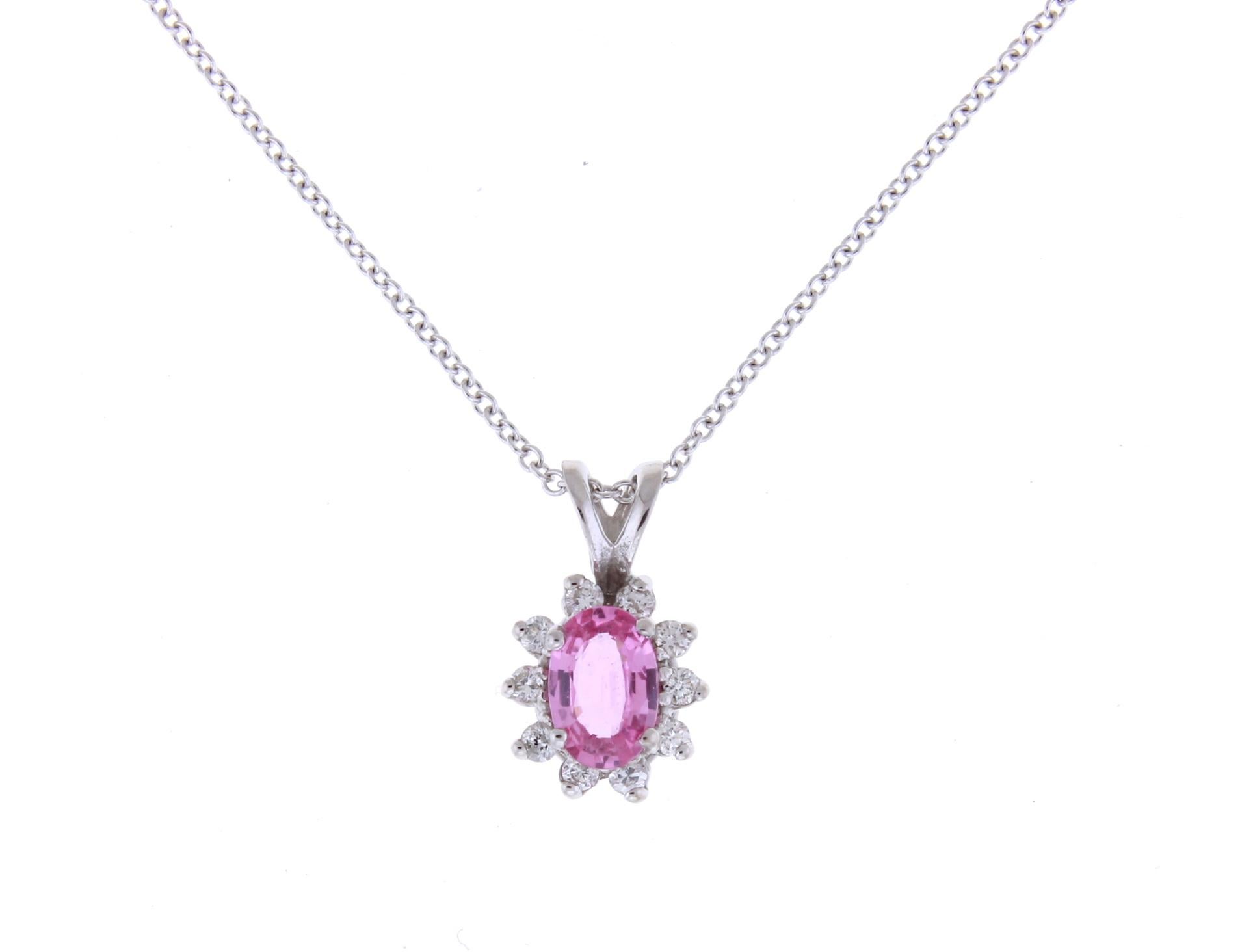 Material: 14k White Gold 
Center Stone Details: 0.5 Carat Oval Pink Sapphire 6 x 4 mm
Mounting Diamond Details: 10 Round White Diamonds Approximately 0.12 Carats - Clarity: SI / Color: H-I
Chain: 18 inch

Match this with our 0.57 Carat Oval Pink