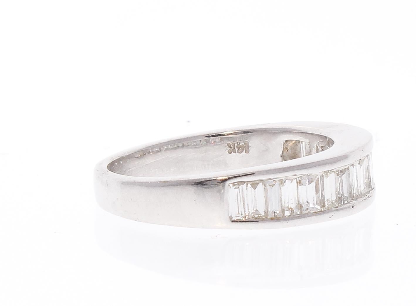 This brightly polished 14 karat white gold diamond wedding stackable ring exudes ultimate style and prestige with its incredible sparkle and fire. A total of 0.50 carats of 14 shimmering baguette cut diamonds are arranged in a stunning row along the
