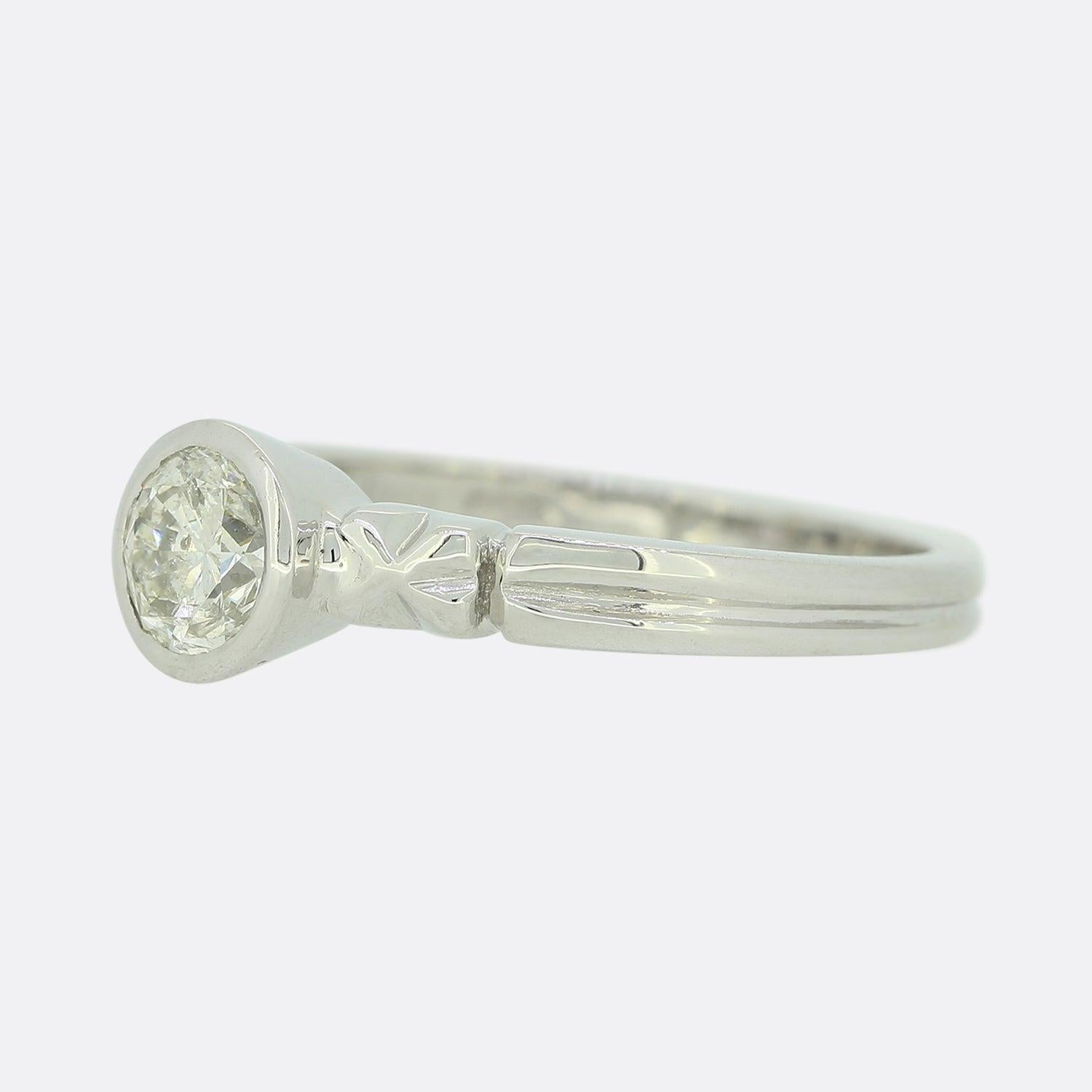 This is a a wonderfully simple platinum diamond solitaire ring. The pieces features a single round brilliant cut diamond in a rub-over setting and is finished with a pair of bowed shoulders and a split shank.

Condition: Used (Very Good)
Weight: 4.5