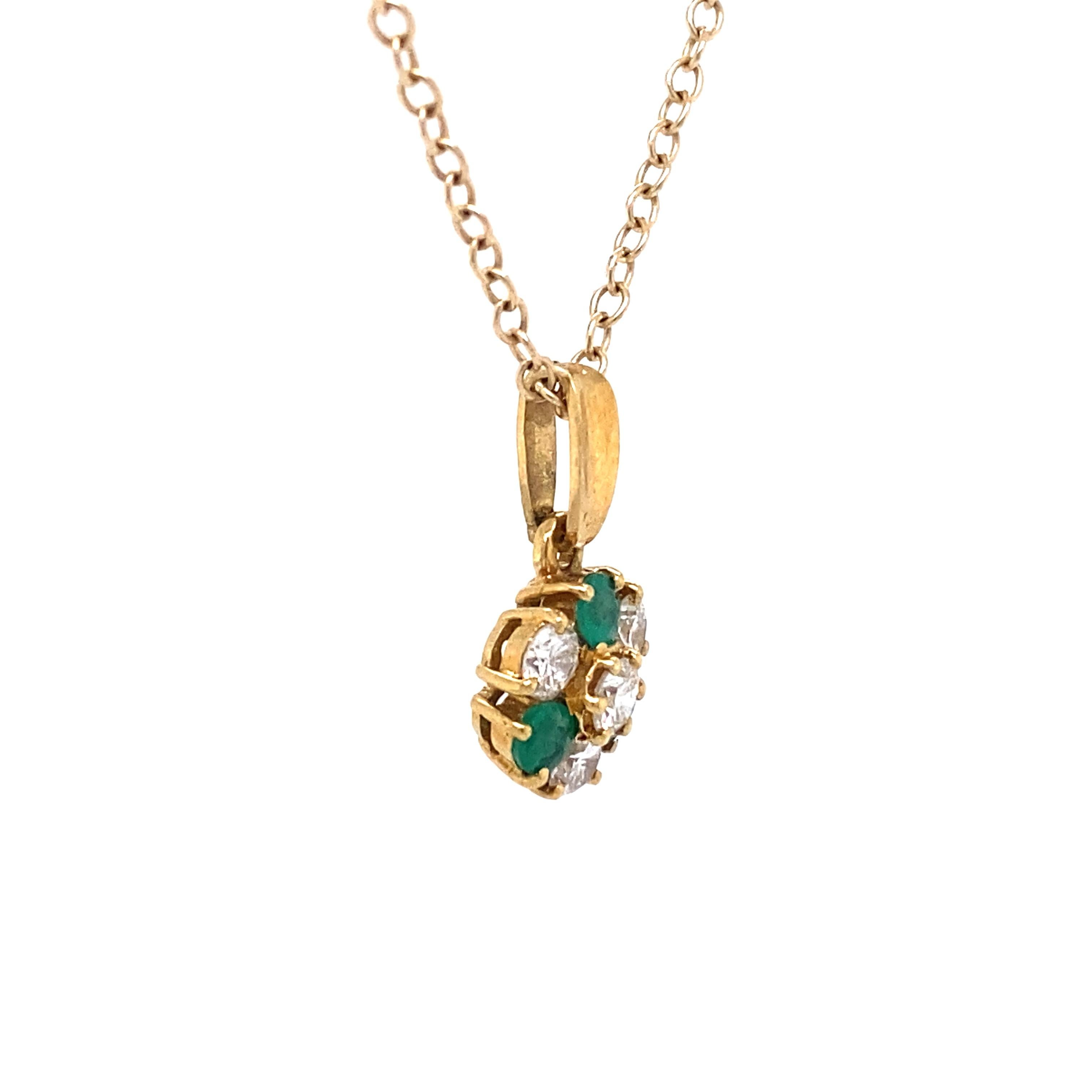 Chain not included.

Circa: 1970s
Metal Type: 18 Karat Yellow Gold 
Weight: 1.5 grams
Dimensions: 0.5in Length including bail

Diamond Details:
Carat: 0.50 carat total weight
Cut: Round
Color: G 
Clarity: VS

Emerald Details:
Cut: Round
Origin: