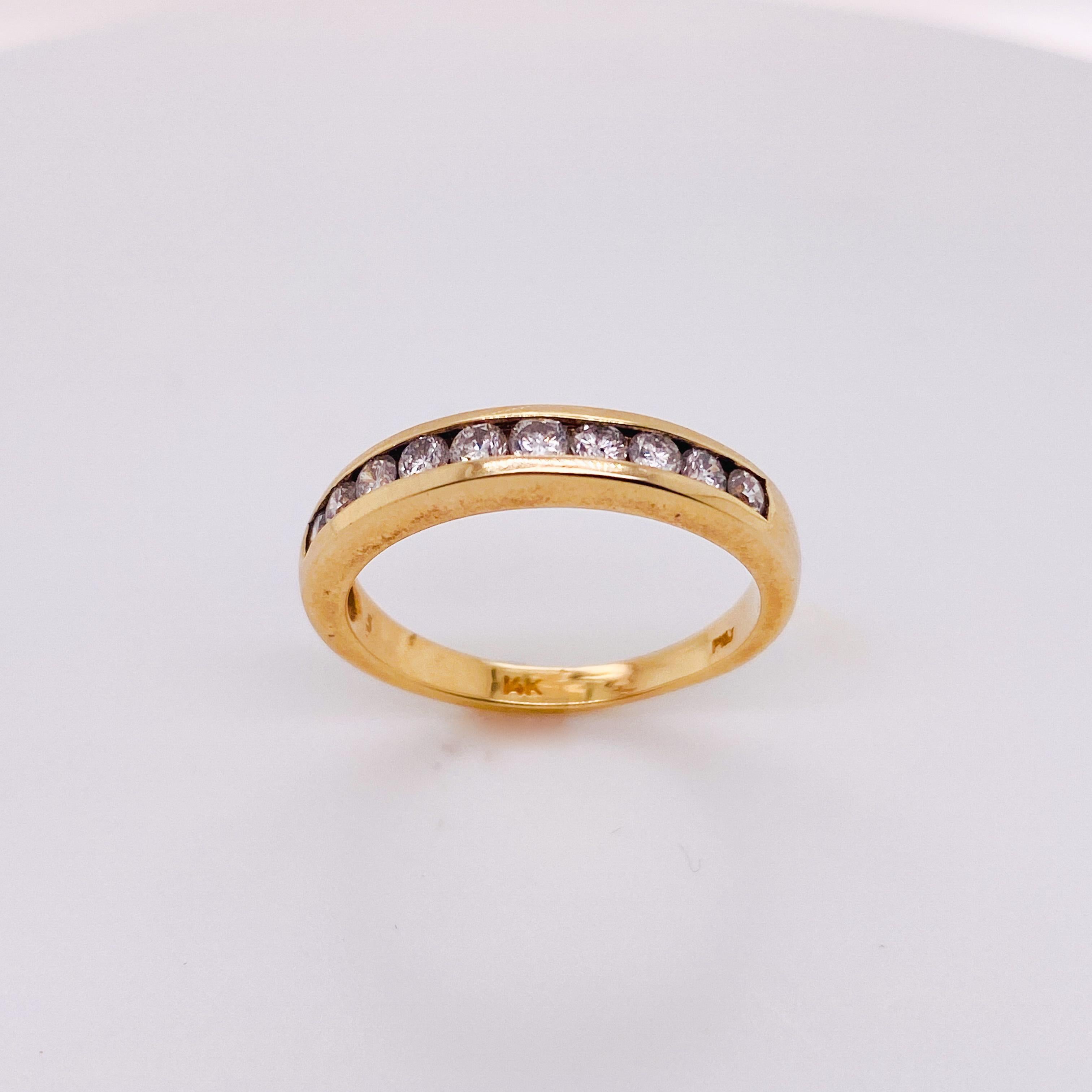 A channel of diamonds curve around the top of your finger. The 14 karat yellow gold channel creates a beautiful edge along the sides of the ten diamonds that seem to float next to each other inside their seats. The sides of the ring are flat and
