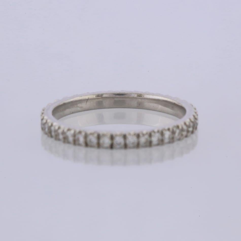 This is a platinum diamond full eternity ring.

Condition: Used (Excellent)
Weight: 2.6 grams
Size: L
Band Width: 2mm
Total Diamond Carat Weight: Approx. 0.50 carats
Diamond Centre Stone: Colour: G-H, Clarity: VS
Hallmarked: Yes
Box: The Vintage