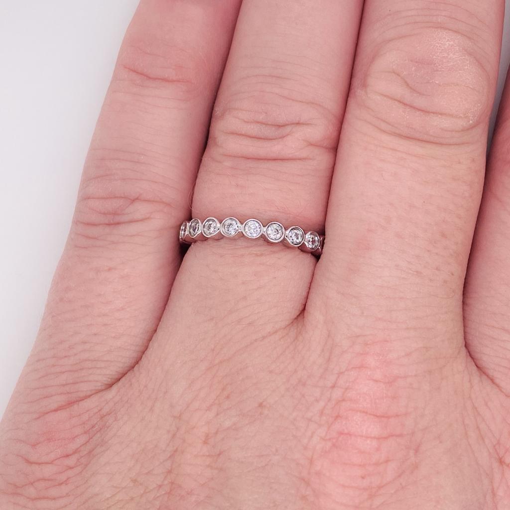 Wrap your finger in circles of diamonds that sparkle inside their protective metal wraps. The bezels have smooth rounded edges that are gentle on your fingers. The tapered metal at the base of the ring allows for finger size changes that happen