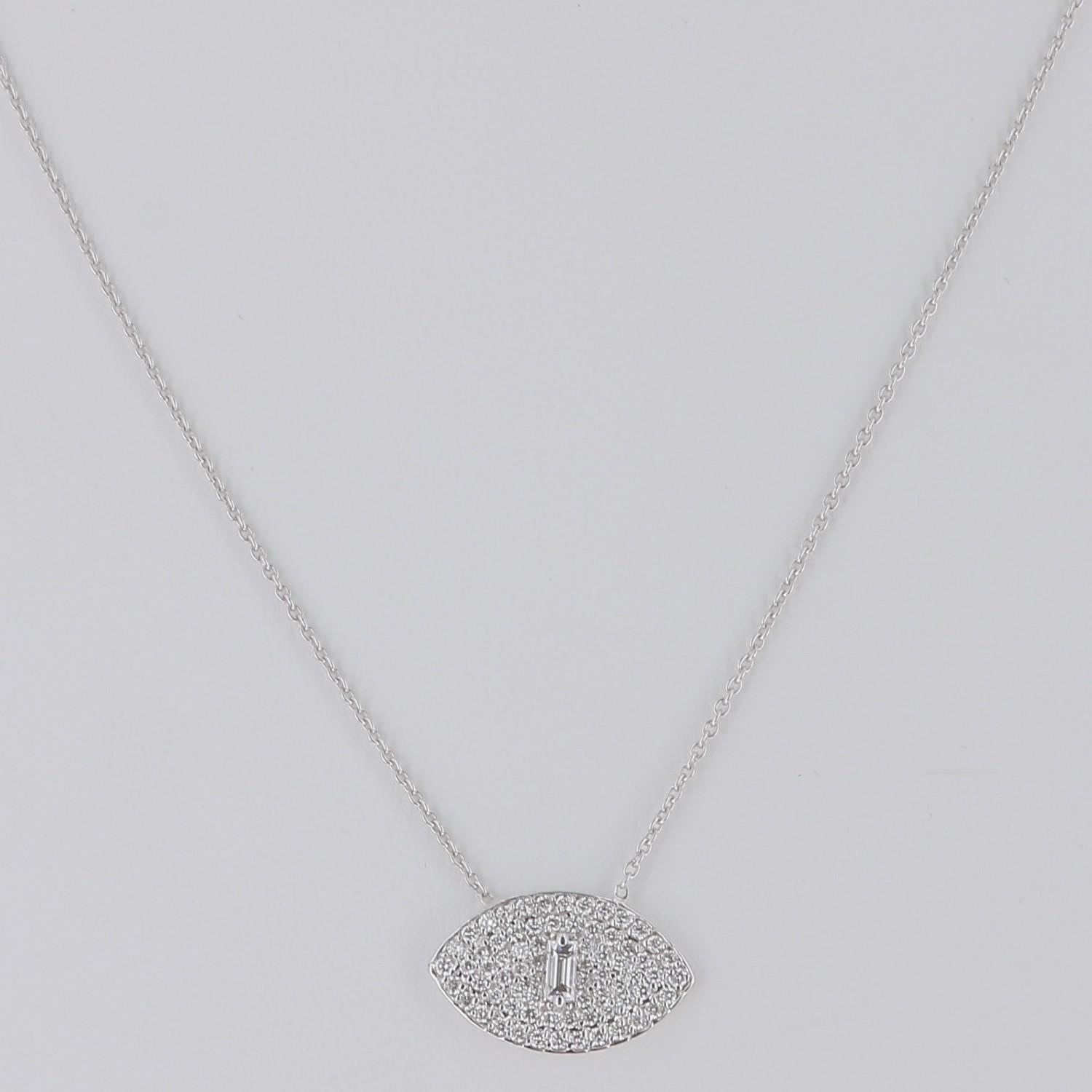 The diamond Pendant necklace is shape as an eye, totally paved by diamonds weighing 0,50 carats suspended from a chain of 40 cm.
The Eye necklace is set with one baguette diamond weighing 0.10 Carat and round diamonds weighing 0.40 Carat.
The Chain