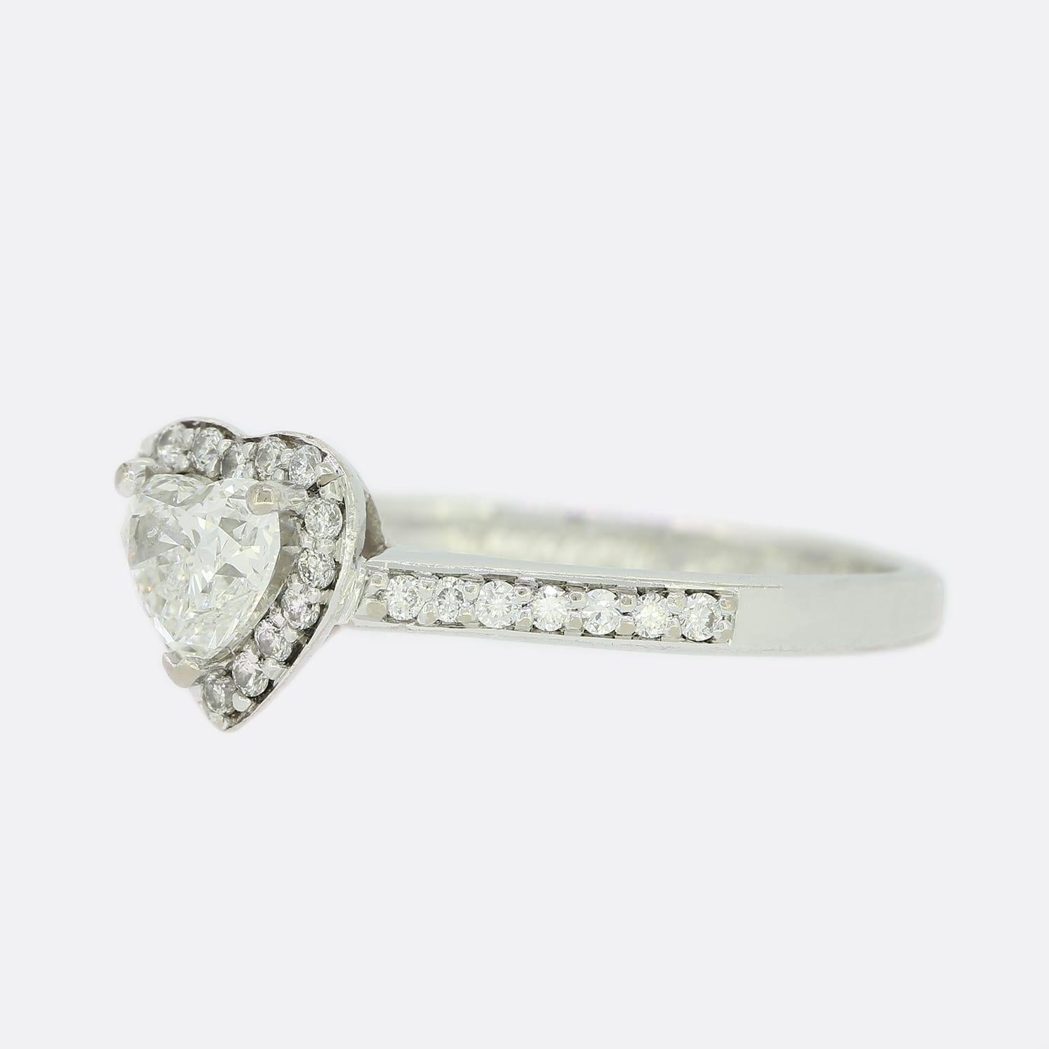 This is a single stone heart shape diamond engagement ring. The ring consists of a heart shape diamond held in a 3 claw setting with a brilliant cut diamond halo crafted in 18ct white gold.

Condition: Used (Very Good)
Weight: 3.0 grams
Size: