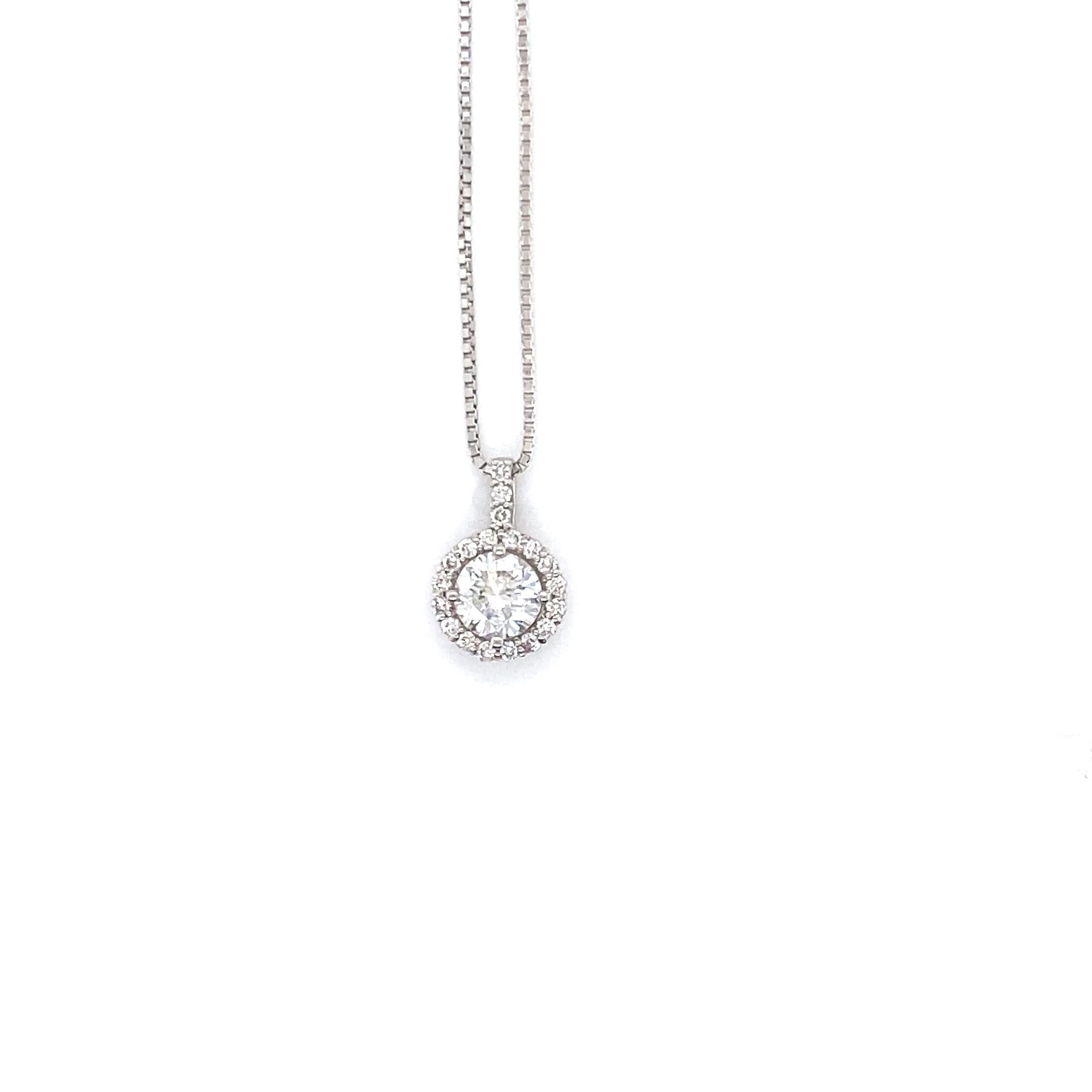 A stunning Pendant Necklace featuring a natural 0.50 Carat Round Brilliant Diamond (center) and 0.10 Carats of Diamond Accents set in Platinum. The Diamond's grade is H, SI-2, Very Good. Diamonds have been adorned and cherished throughout human