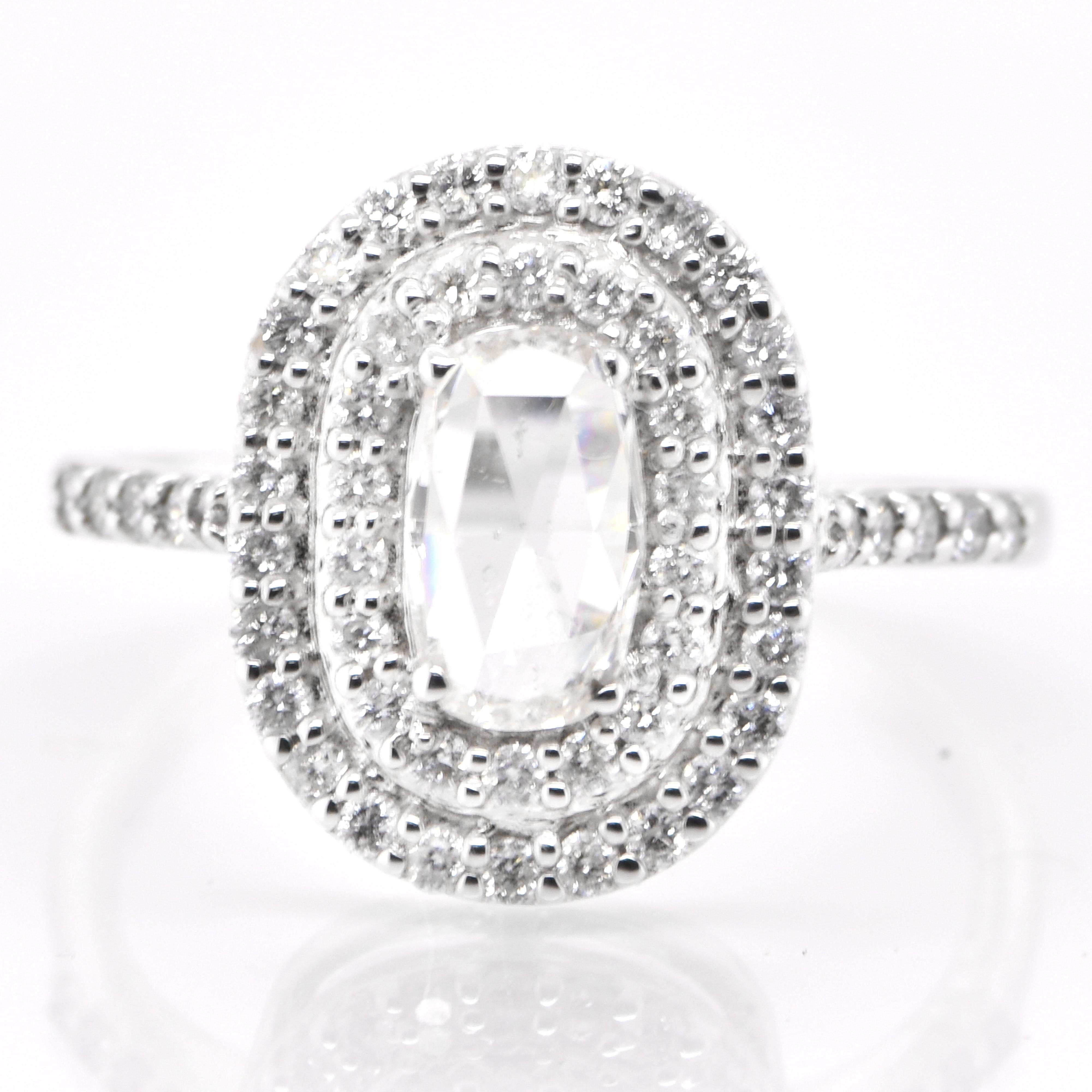 Une magnifique bague double halo comprenant un diamant naturel taille rose de 0,50 carat et des accents de diamant de 0,59 carat sertis en platine. Les diamants ont été parés et chéris tout au long de l'histoire de l'humanité et remontent à des