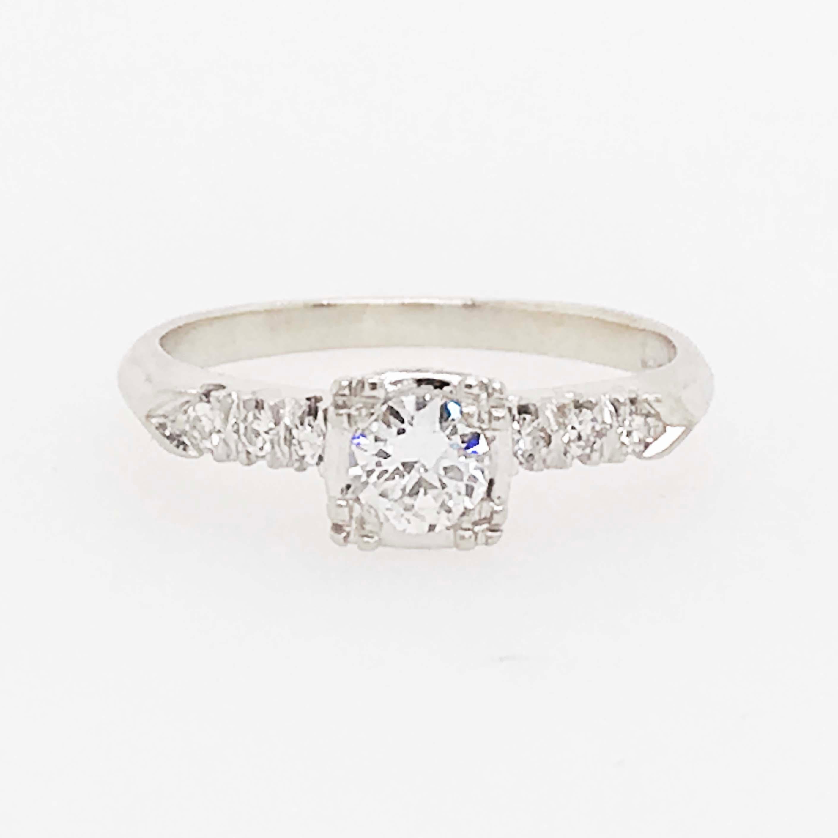 This is a very special estate diamond engagement ring. With all of the original diamonds set in the original platinum setting! Set in the center of this estate engagement ring is an Old European cut diamond! 
The Old European cut diamonds are round