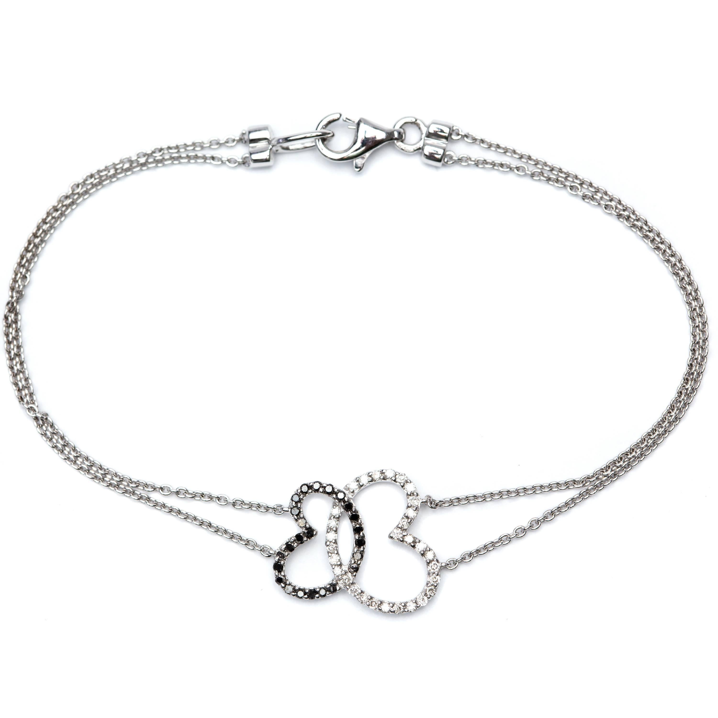 Ornez votre poignet avec cet élégant bracelet en forme de double cœur en diamants brillants ronds H-SI1 de 0,30 ct avec 0,20 ct de diamants noirs, un magnifique bijou serti en or blanc 18 carats.