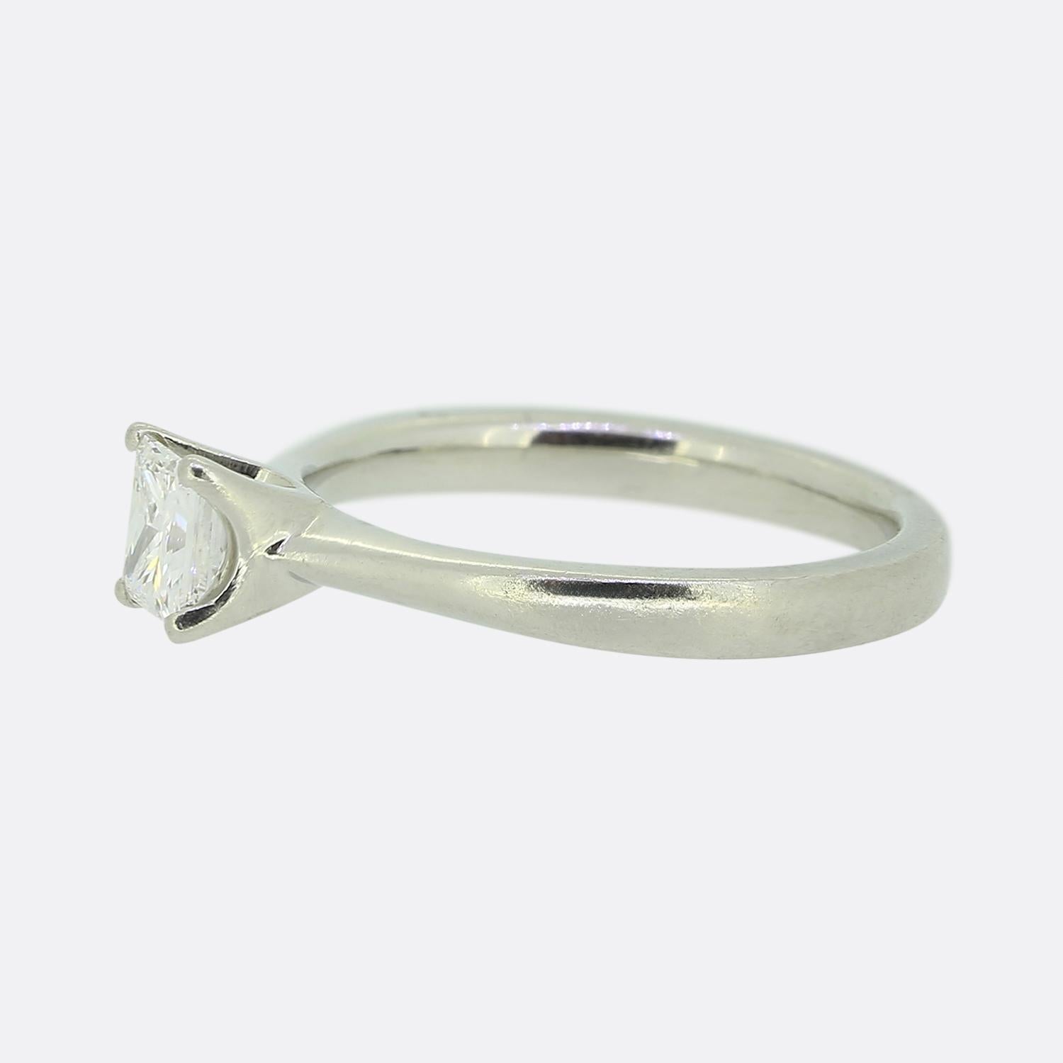 Here we have a platinum engagement ring featuring a stunning square modified brilliant-cut diamond. This captivating stone sits alone in a four-clawed setting atop a plain slimming band whilst boasting a bright white colour tone. 

Condition: Used