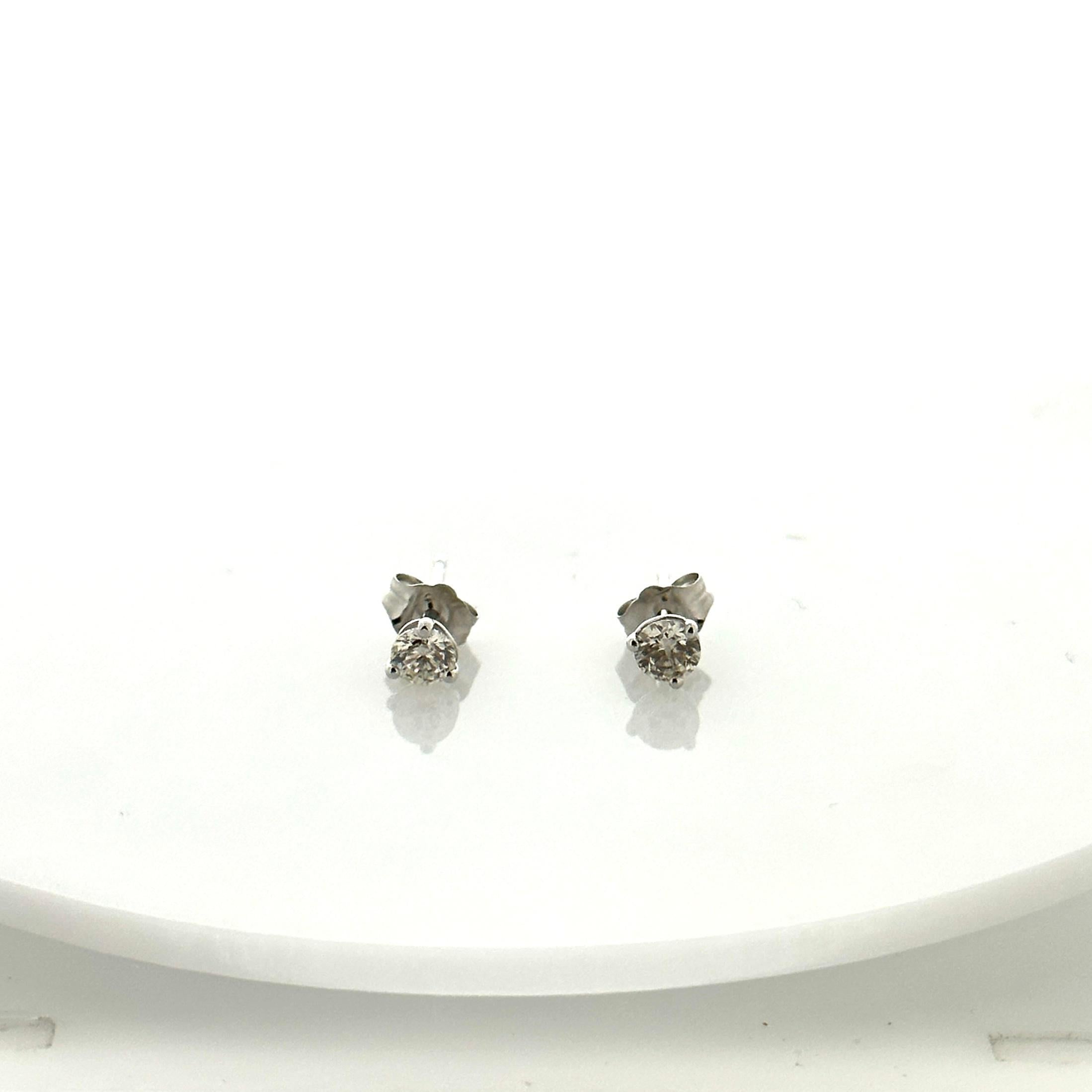 Stunning 14 Karat white gold handmade earrings featuring 2 round brilliant cut diamonds weighing 0.50 carat total I-J color and SI1 clarity. These gorgeous earrings are classic and timelessly elegant.
