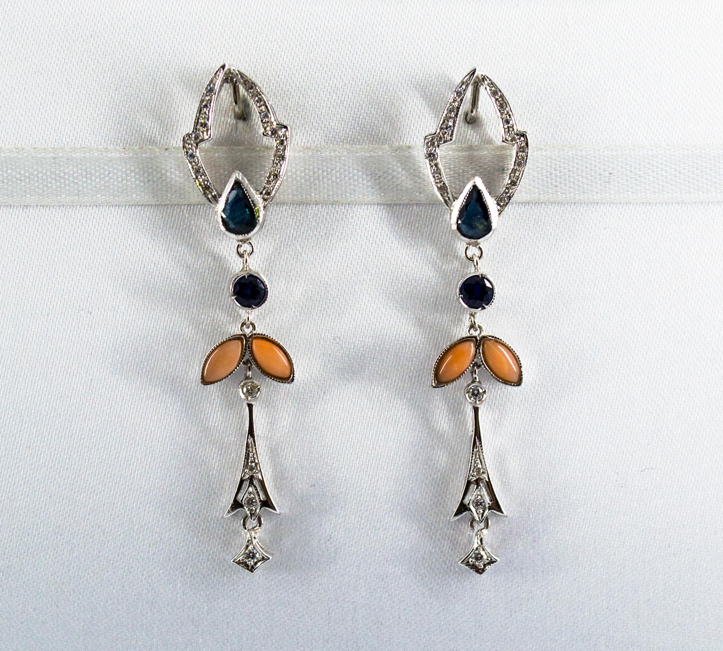 These Stud Drop Earrings are made of 14K White Gold.
These Earrings have 0.50 Carats of White Diamonds.
These Earrings have 1.30 Carats of Blue Sapphires.
These Earrings have also Pink Coral.
All our Earrings have pins for pierced ears but we can