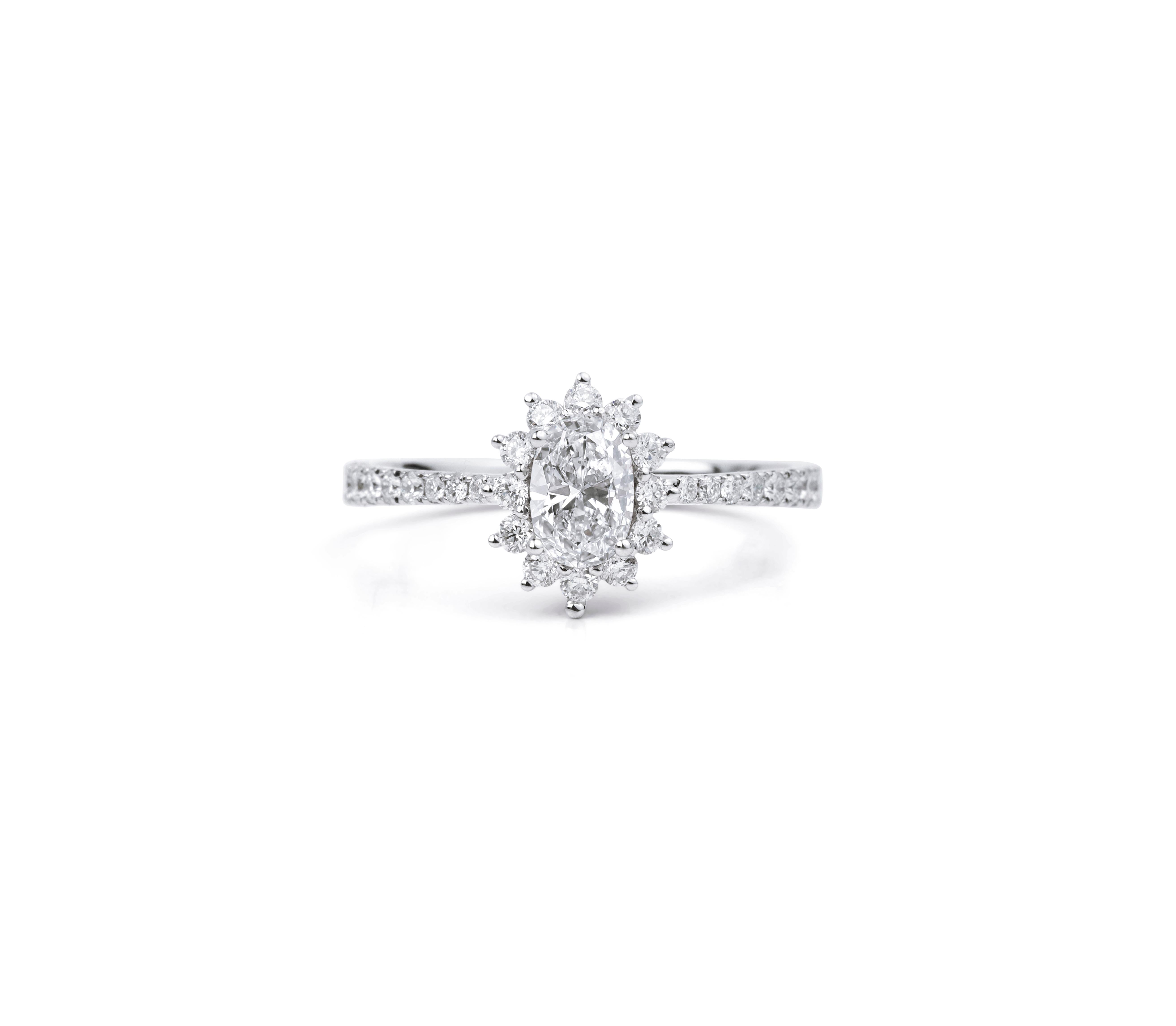 A celebration of timeless elegance and enduring love, this handcrafted halo engagement ring showcases a radiant 0.50 carat natural oval-cut diamond, masterfully set in 18K white gold. GIA-certified, the center stone features exceptional VS clarity
