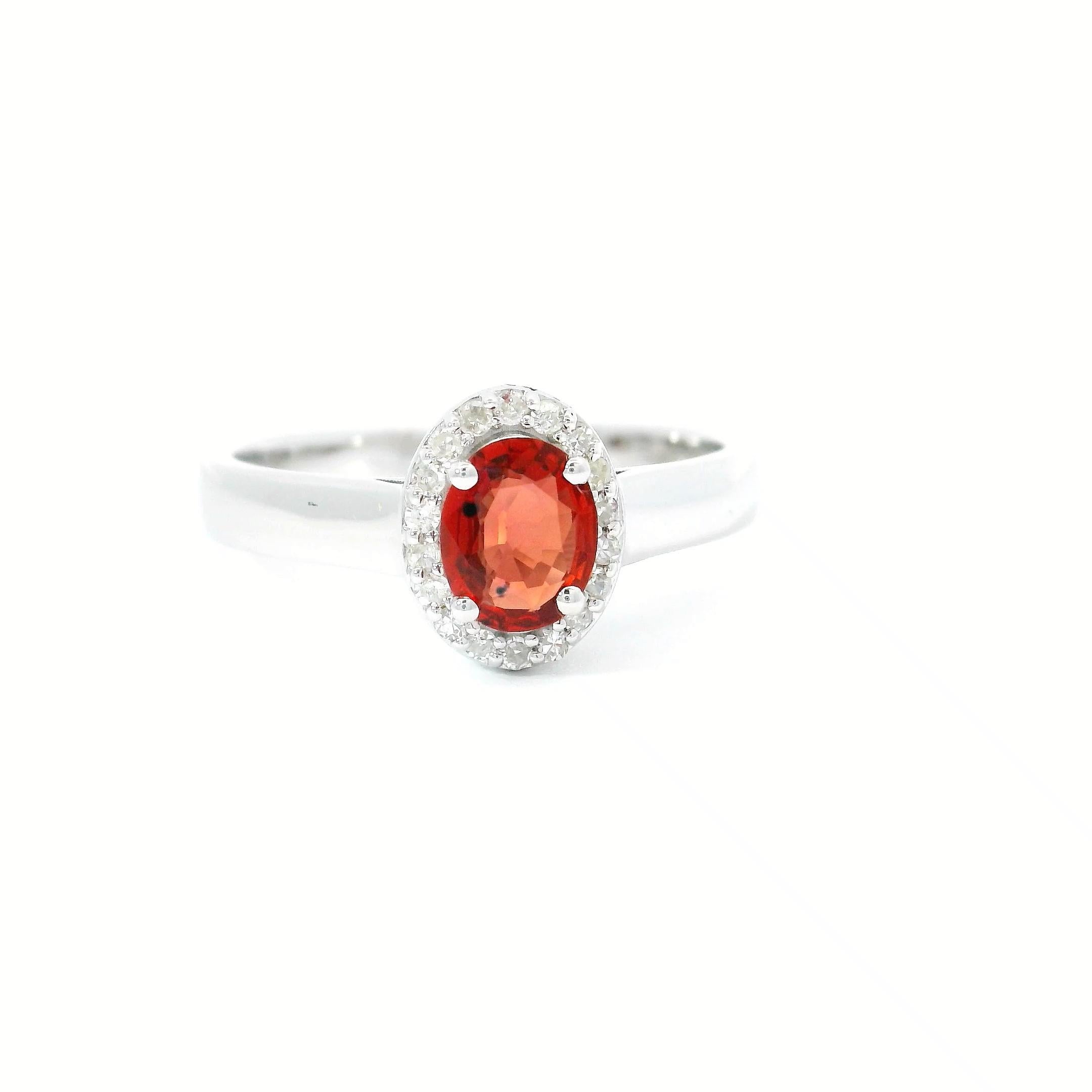 18kt white gold Sapphire Ring
  
  Gold colour & karat: White gold 18kt
  Weight: 3.63 grams
  
  Set with-
  Stone type: Diamond
  Shape: Oval
  Carat: 0.50 cts
  Colour: Red Colour
  
  Surrounding Stones: Diamonds
 1) White Diamonds
  Carat