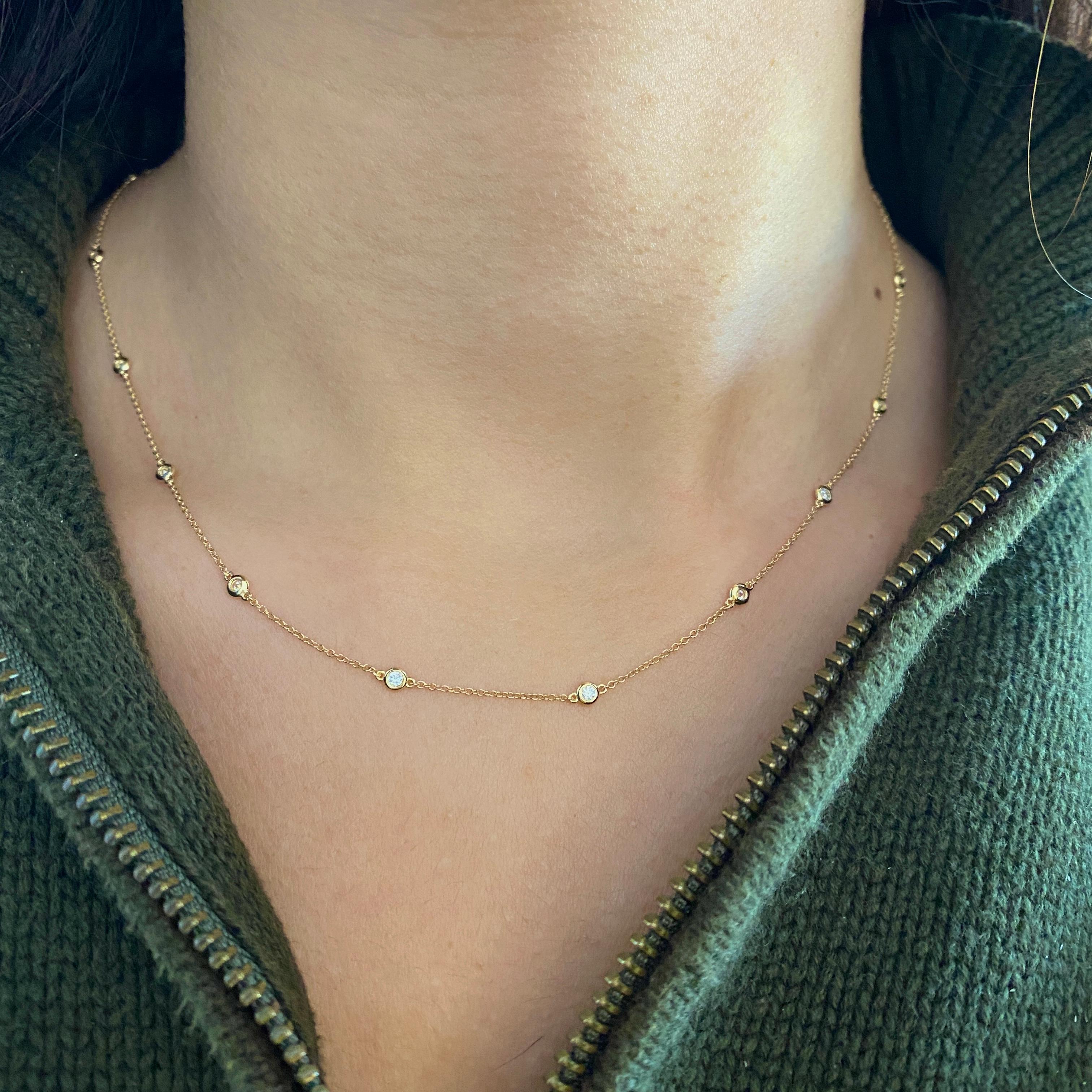 This slim diamond station necklace is a fabulous piece for any day. It layers beautifully for dressing up or dressing down! Fifteen diamonds are set in bezels and spaced about an inch apart across the lovely cable chain. The necklace can be worn by